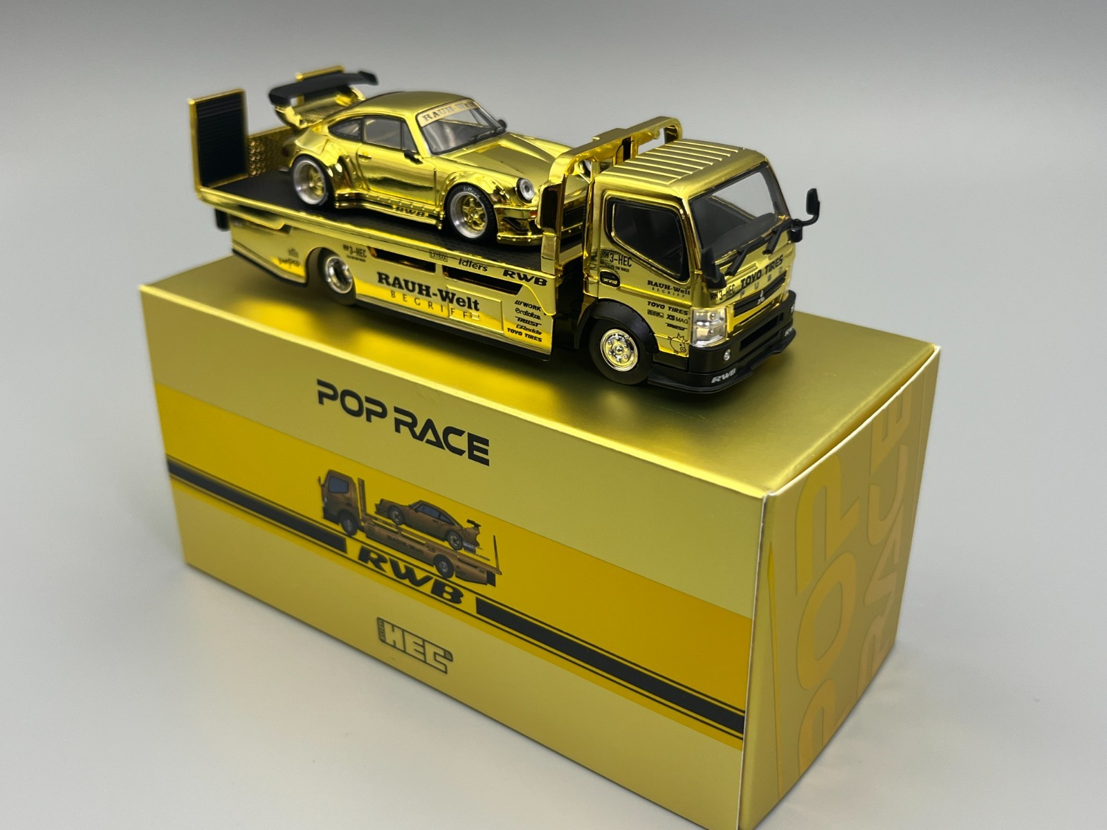 RWB 930 and Transporter Gold Porsche 911 HEC 2026 Exclusive Poprace 1/64 scale