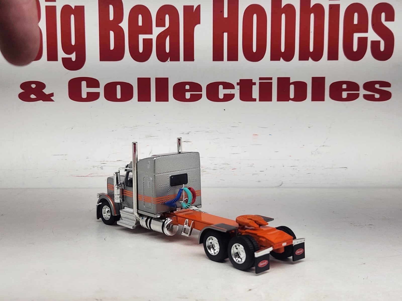 1/64 New DCP Orange & Silver 589 Peterbilt 58″ Mid Roof Sleeper Tractor
