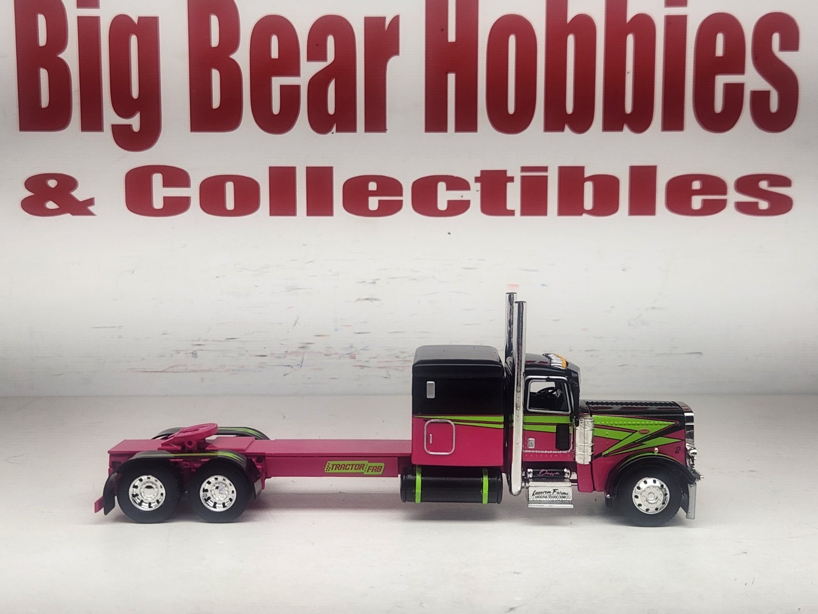 1/64 DCP Loewen Farms Pink, Black 389 Peterbilt With 60″ Flattop Sleeper