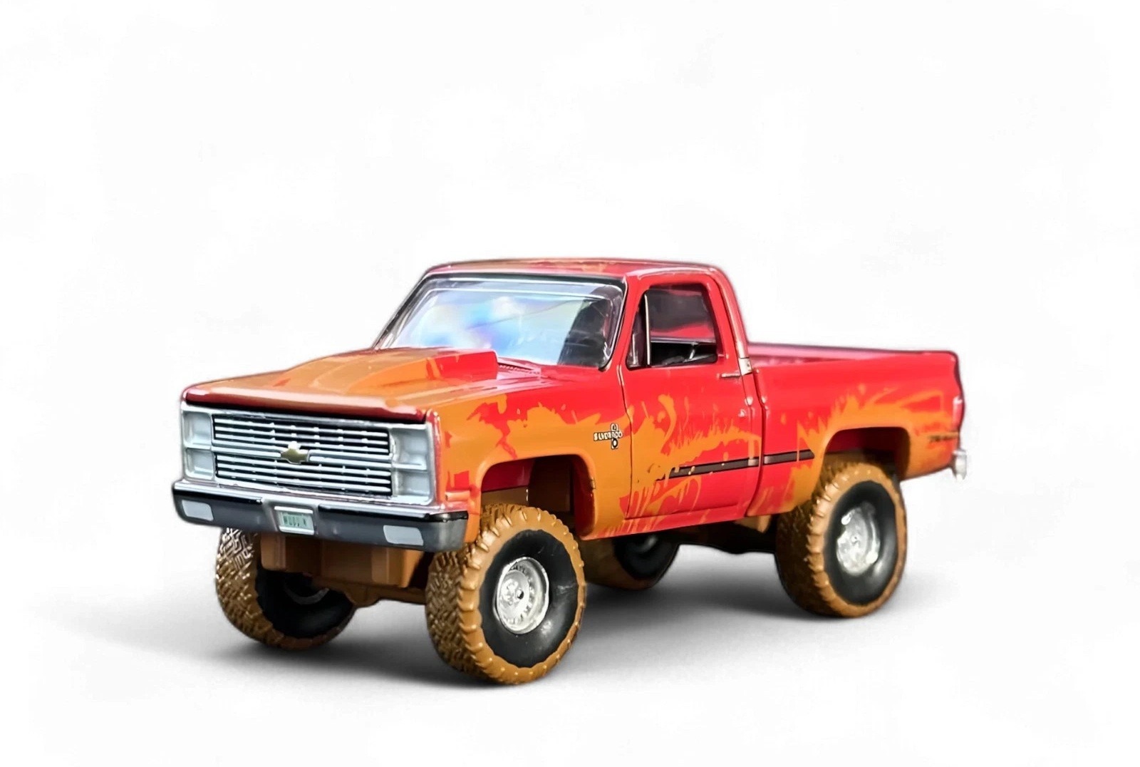 Auto World 1:64 2022 Muddin’ USA R1: Lifted Muddy 1983 CHEVROLET SILVERADO K10
