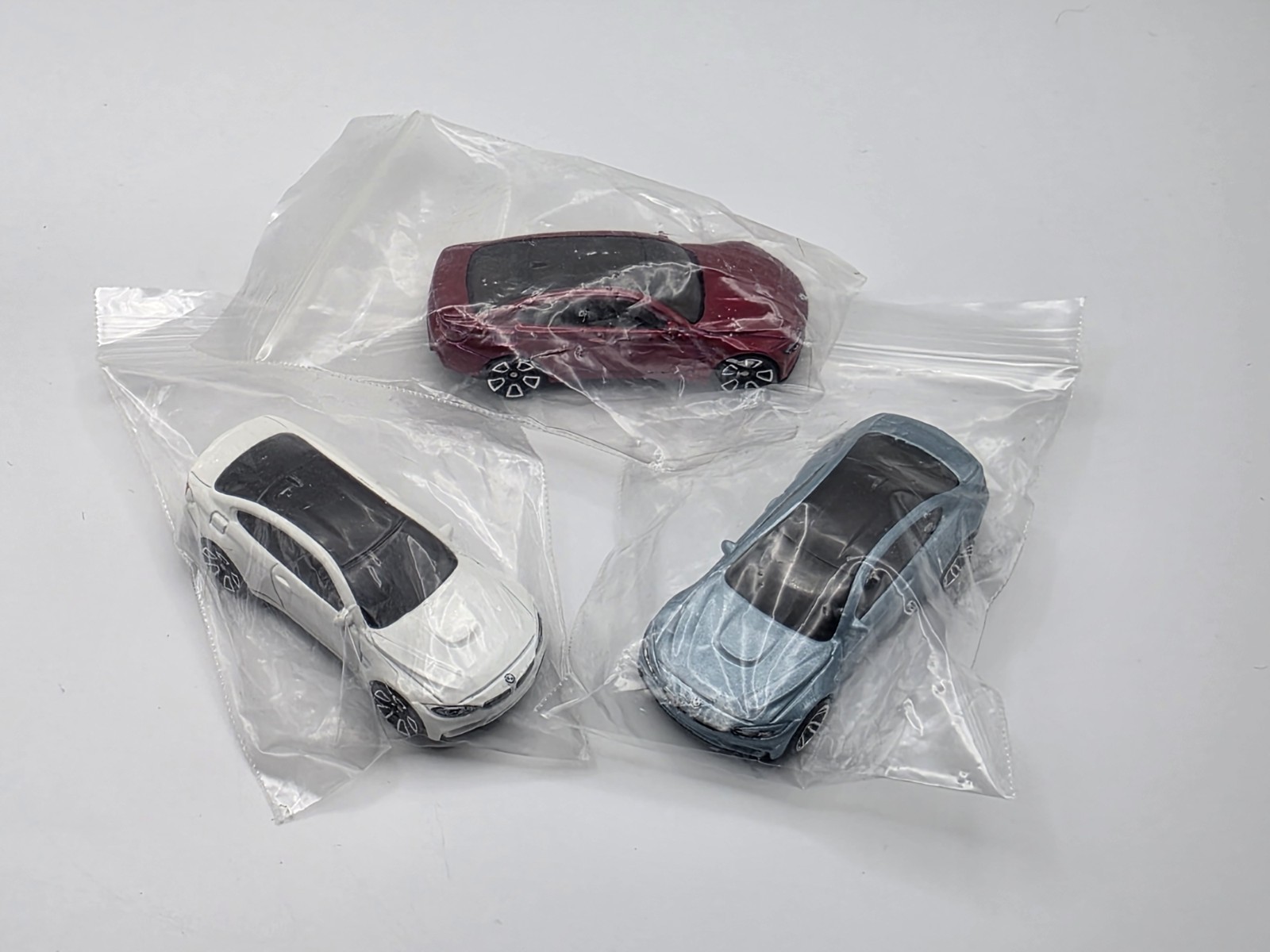 LOT OF (3) LOOSE HOT WHEEL BMW M4 IN LIGHT BLUE METALIC, WHITE AND BURGUNDY
