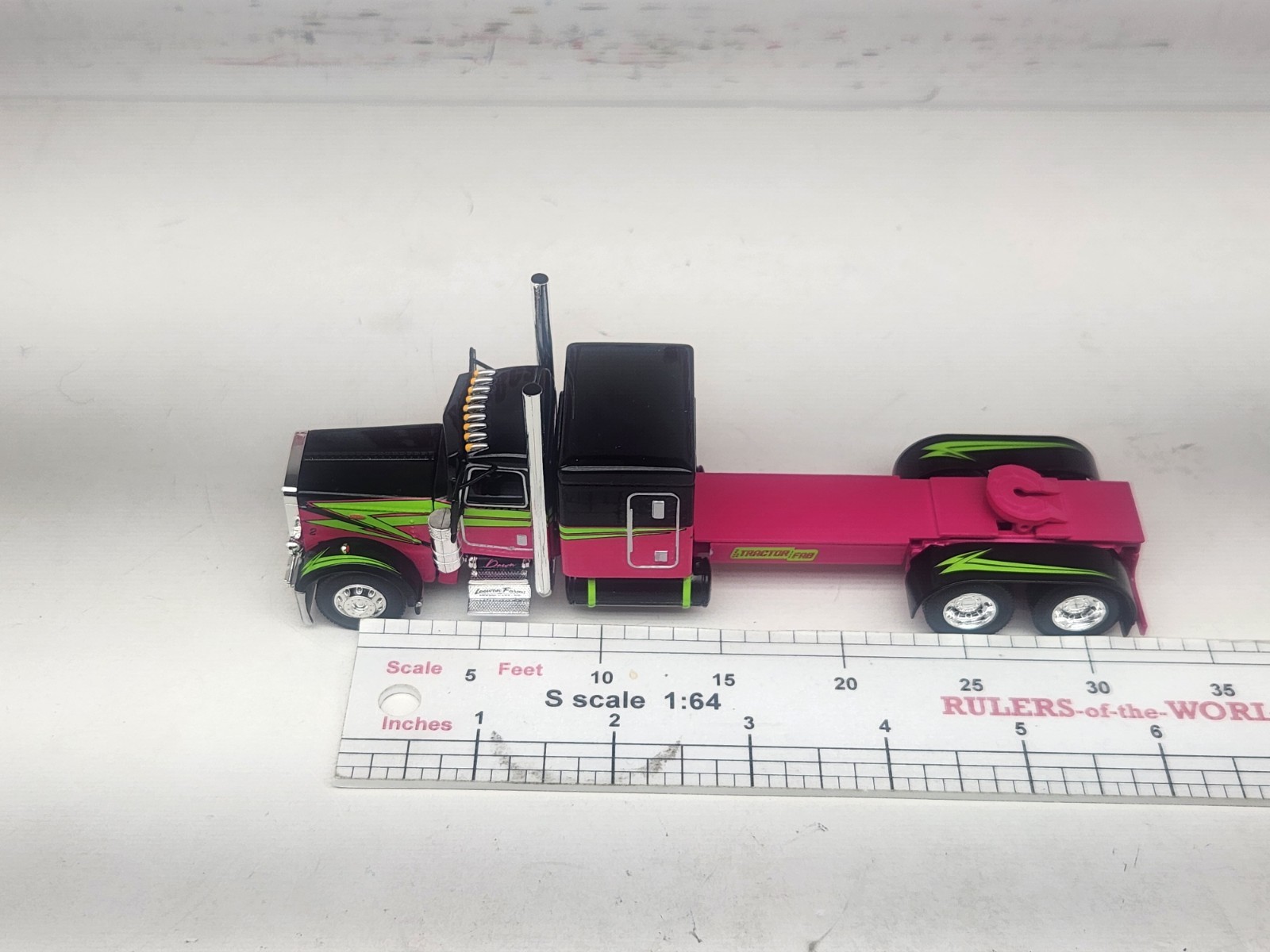 1/64 DCP Loewen Farms Pink, Black 389 Peterbilt With 60″ Flattop Sleeper