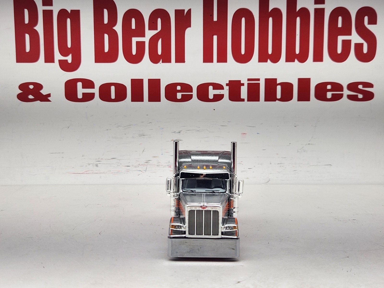 1/64 New DCP Orange & Silver 589 Peterbilt 58″ Mid Roof Sleeper Tractor