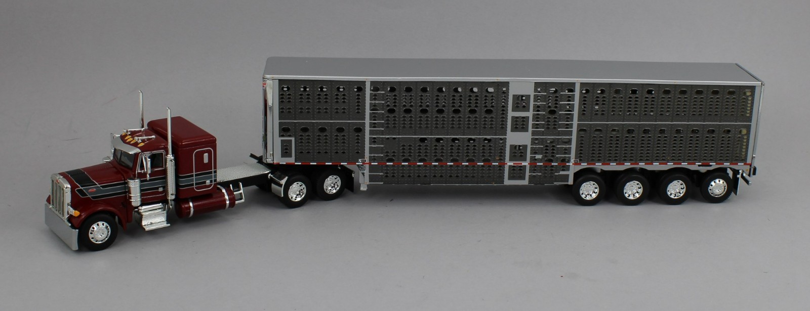 DCP 1:64 *RED* Peterbilt 379 48″ Flattop w/Quad-Axle Wilson Livestock Trailer