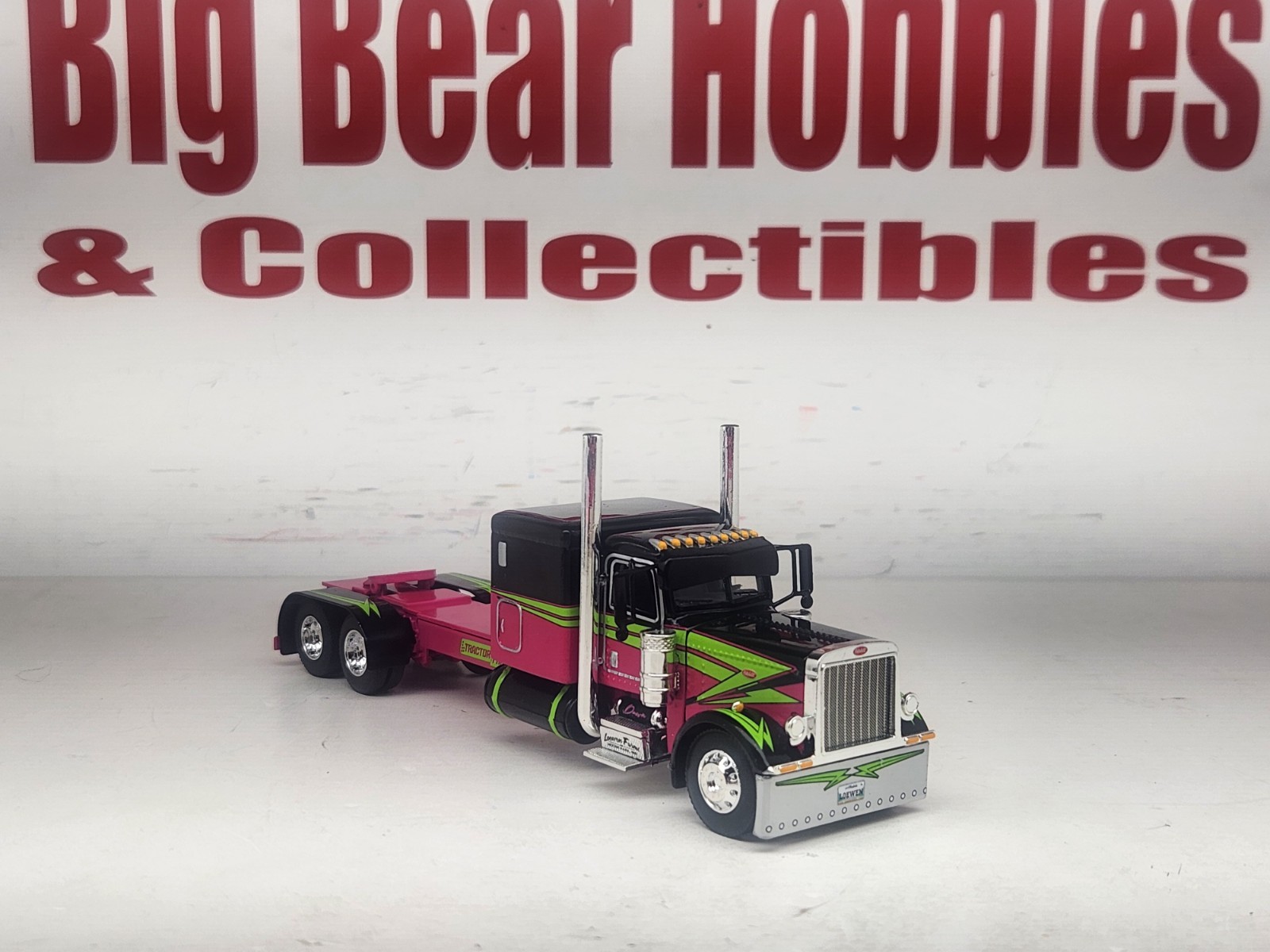 1/64 DCP Loewen Farms Pink, Black 389 Peterbilt With 60″ Flattop Sleeper