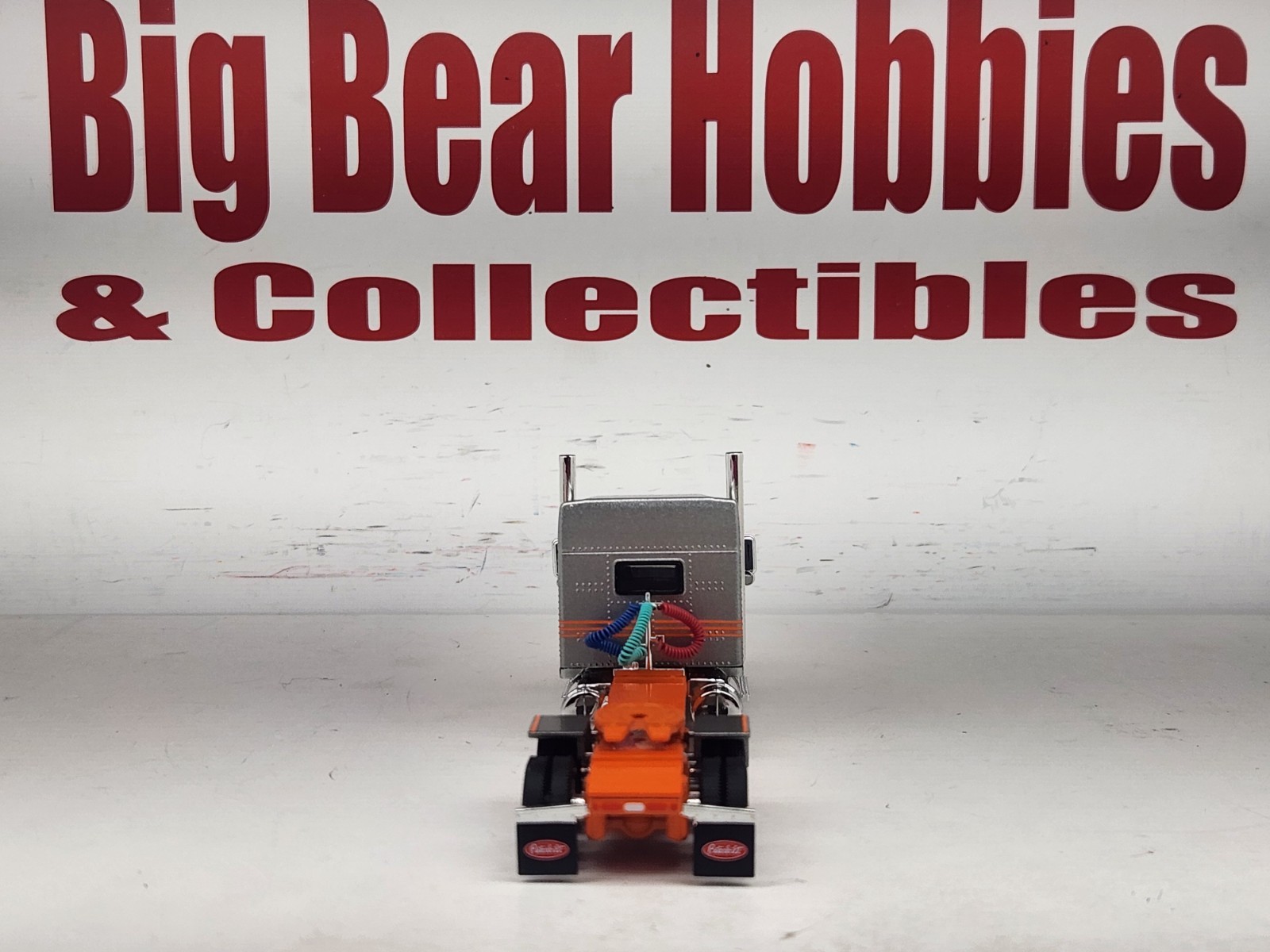 1/64 New DCP Orange & Silver 589 Peterbilt 58″ Mid Roof Sleeper Tractor