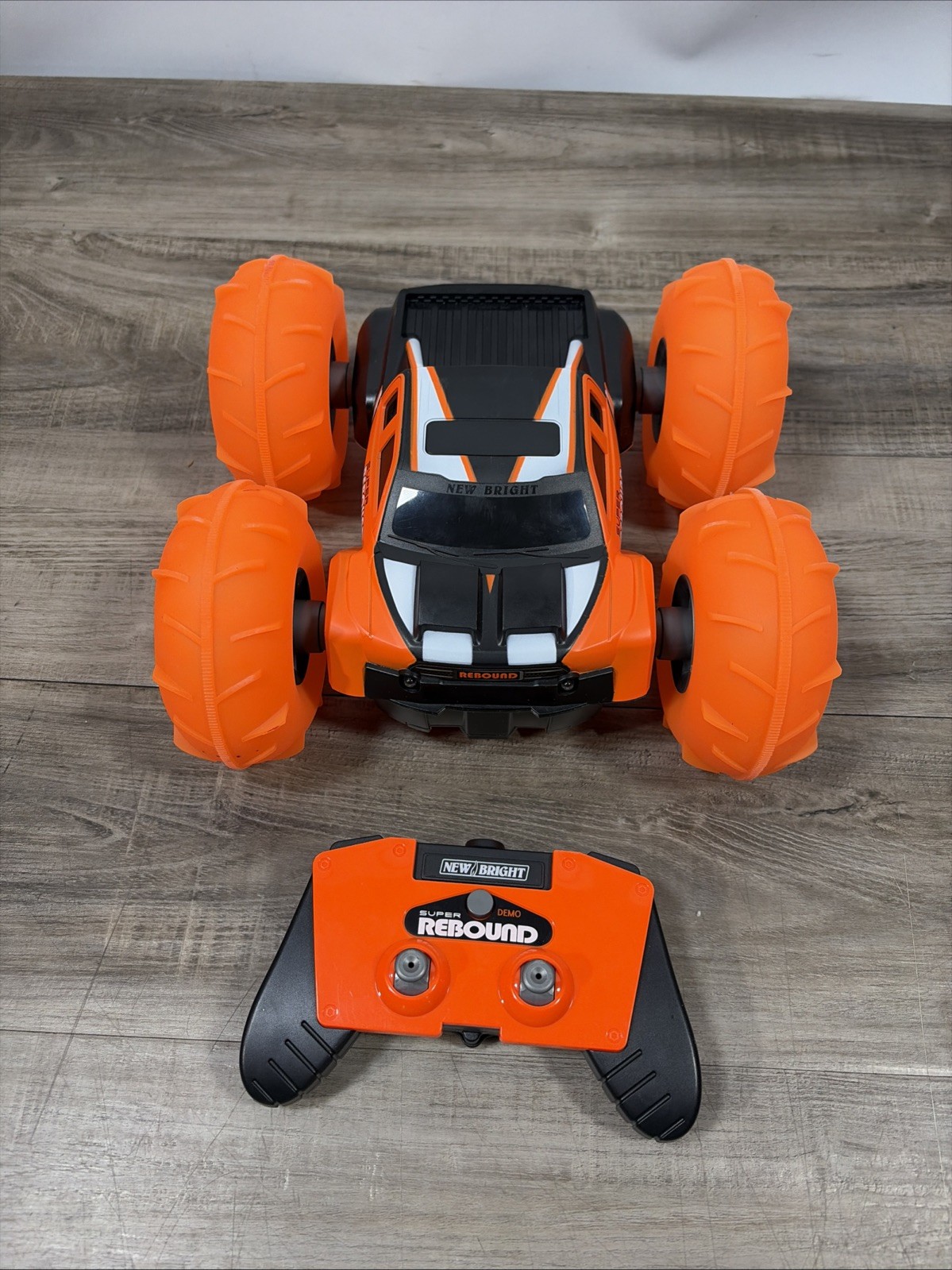 New Bright (1:16) Super Rebound Remote Control Orange Stunt Vehicle READ DESCR..