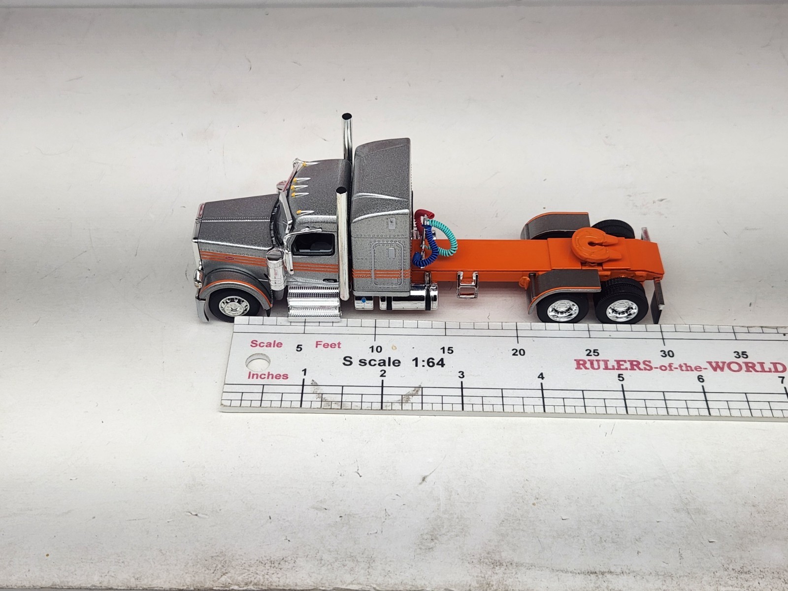 1/64 New DCP Orange & Silver 589 Peterbilt 58″ Mid Roof Sleeper Tractor