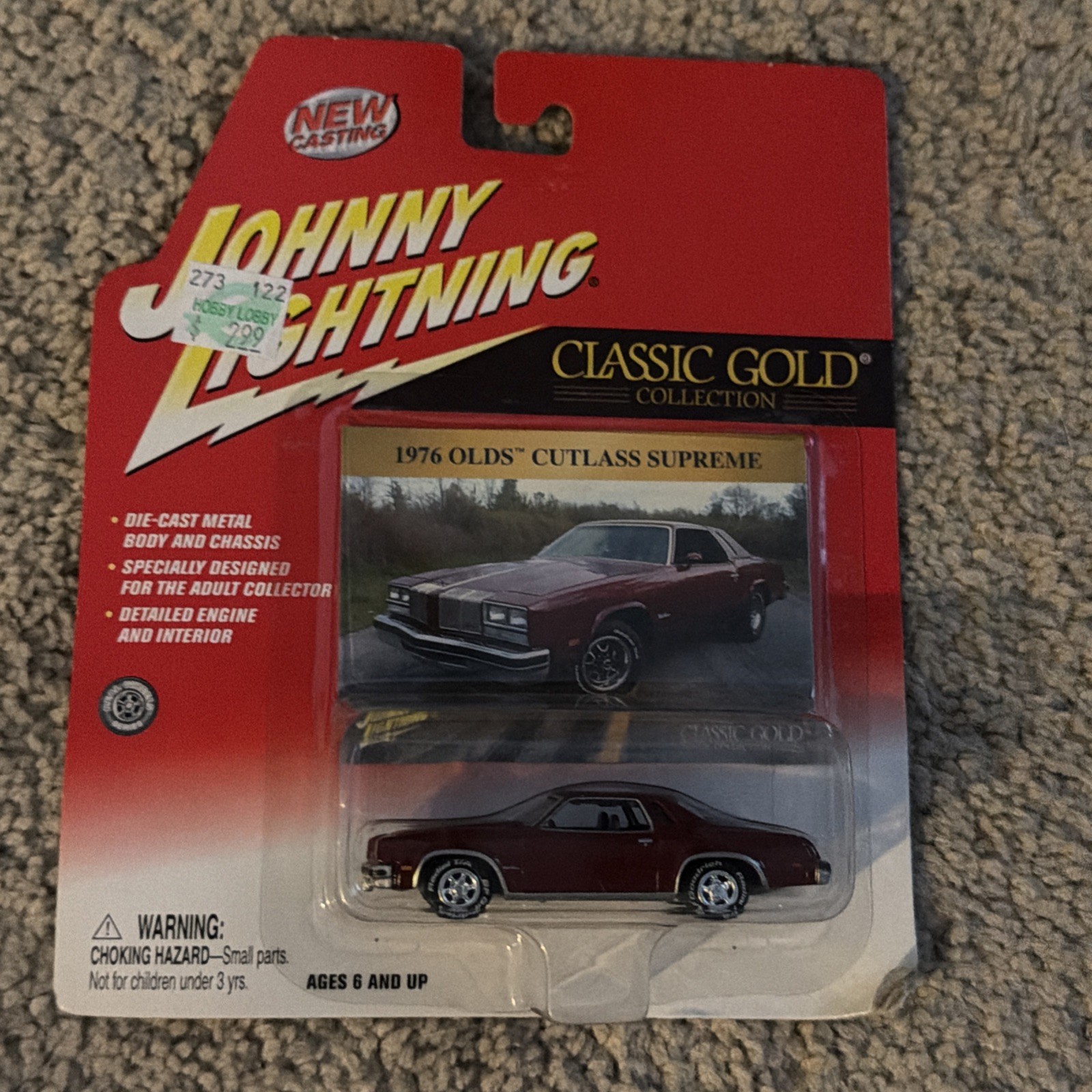 Johnny Lightning 1:64 1976 Olds Cutlass Supreme Lightning Classic Gold NIB