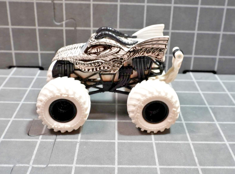 Lot of 4 Hot Wheels including Monster Jam Gears and Galaxies Pirates Curse 1/64