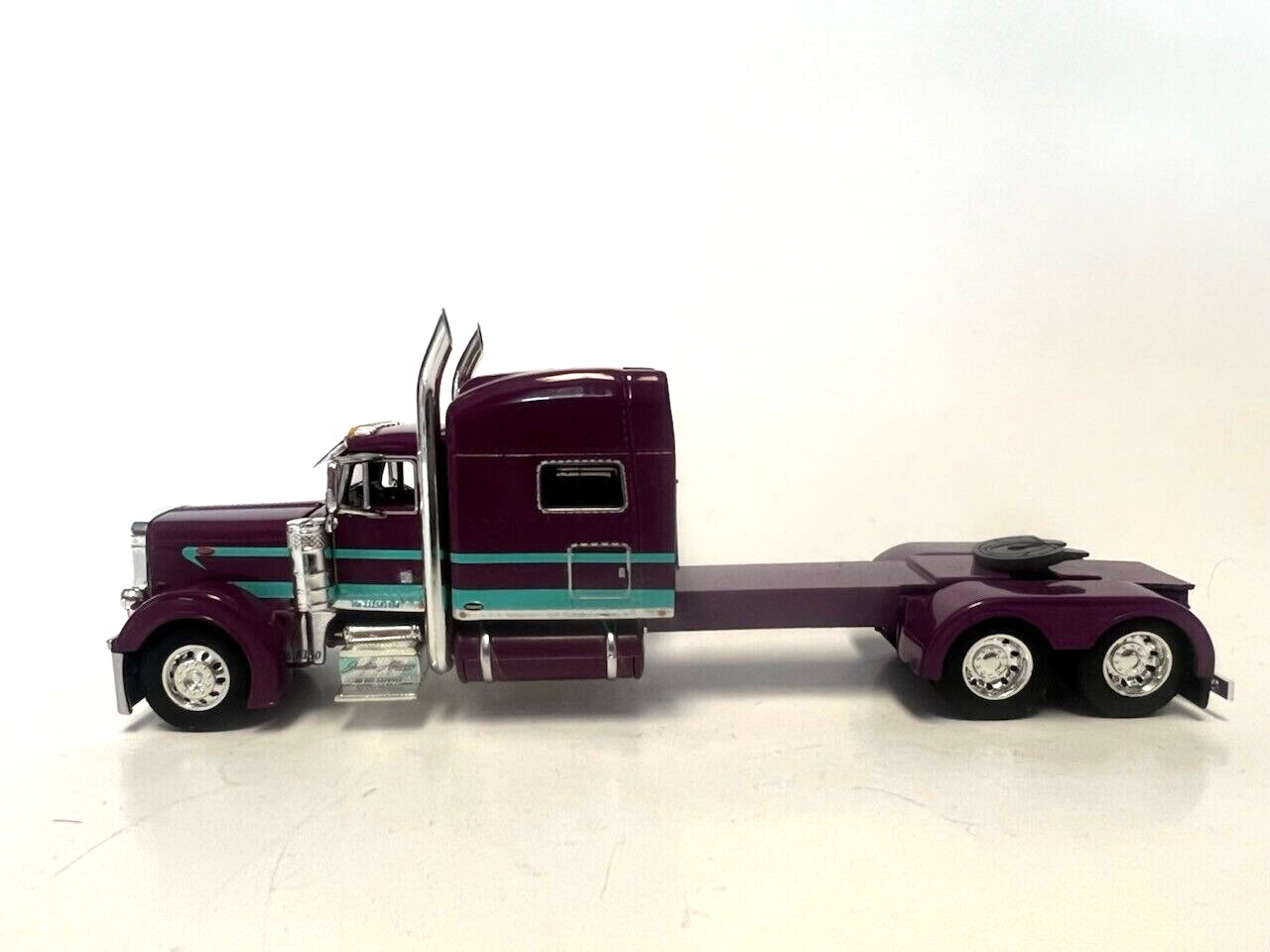 DCP 1/64 SCALE 379 PETERBILT STAND UP SLEEPER, PURPLE WITH TEAL STRIPE