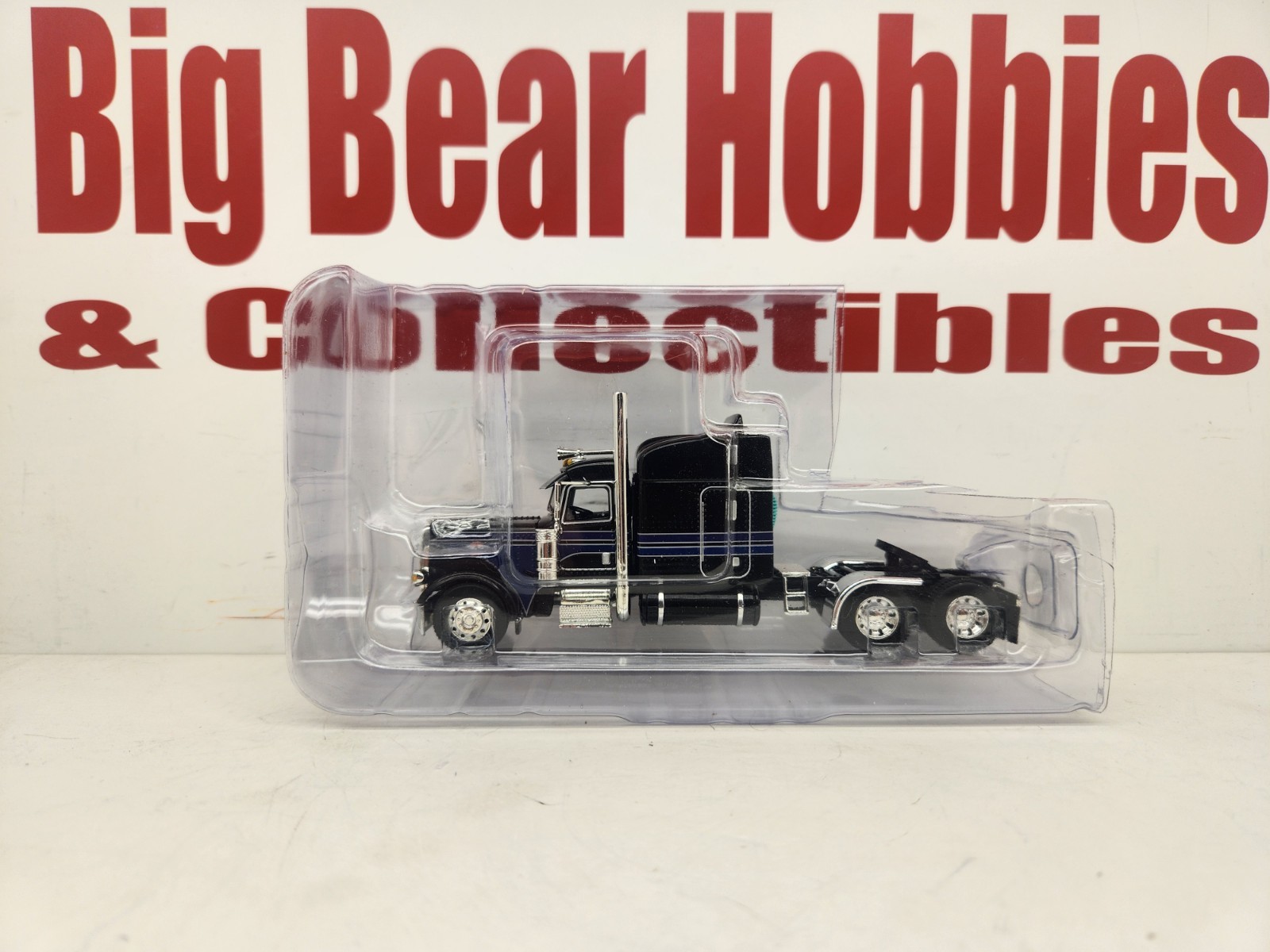 DCP 1/64 Black & Blue Graphics Peterbilt 389 63″ Midroof Sleeper Tractor