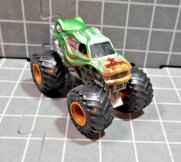 Lot of 4 Hot Wheels including Monster Jam Gears and Galaxies Pirates Curse 1/64
