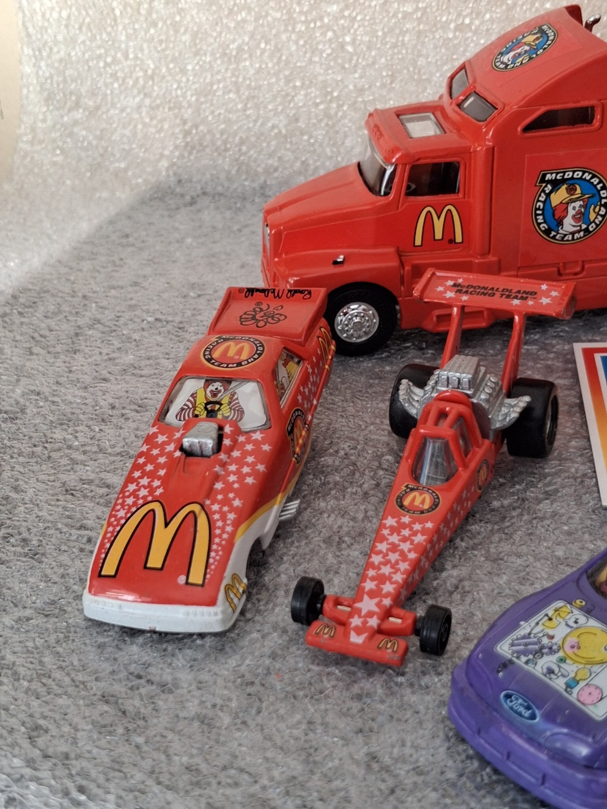 Lot of 1994 McDonaldland Transporter & 7 Car Racing Team set 1-64