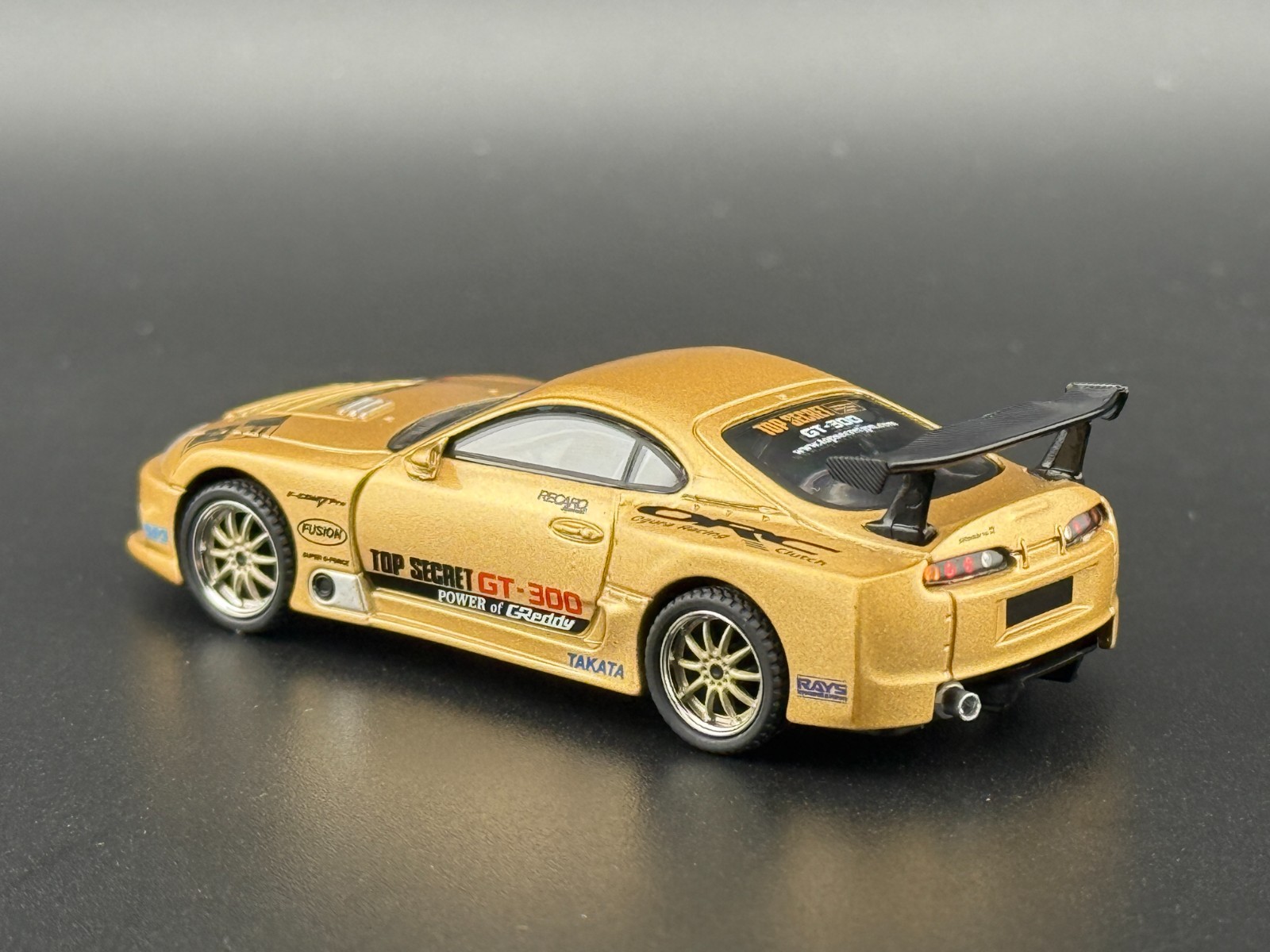 Mini GT Toyota Supra (A80) Top Secret GT-300 – Top Secret Gold #961 1/64