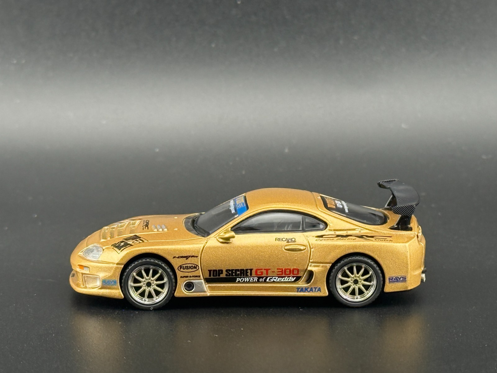 Mini GT Toyota Supra (A80) Top Secret GT-300 – Top Secret Gold #961 1/64