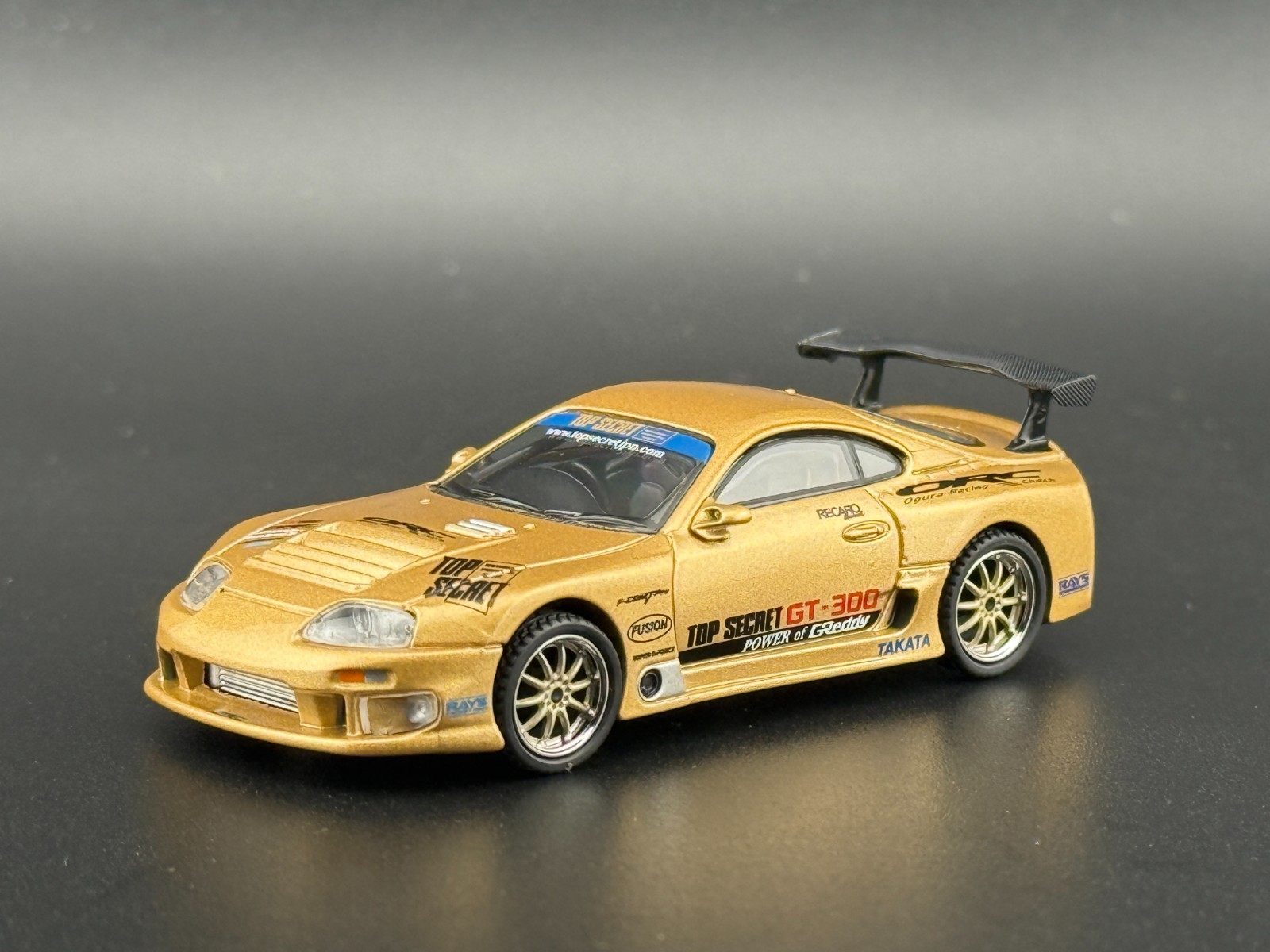 Mini GT Toyota Supra (A80) Top Secret GT-300 – Top Secret Gold #961 1/64
