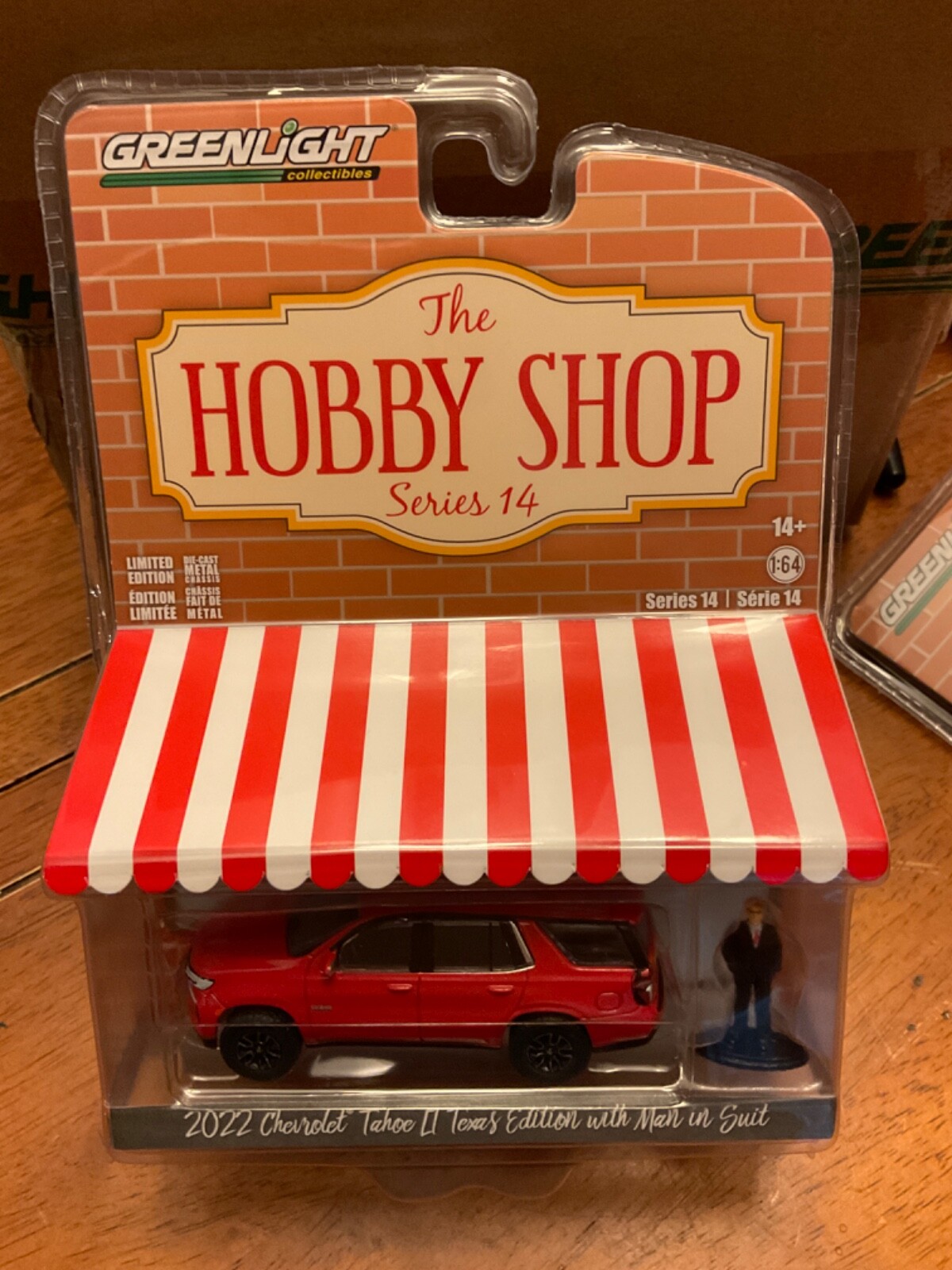 Greenlight Hobby Shop 2022 Chevrolet Tahoe LT Texas Edition with man in suit