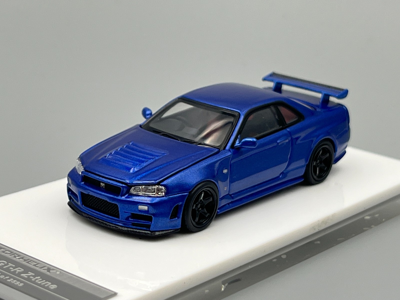Nissan Skyline NISMO R34 GT-R Z-Tune Bayside Blue MotorHelix 1/64 scale display