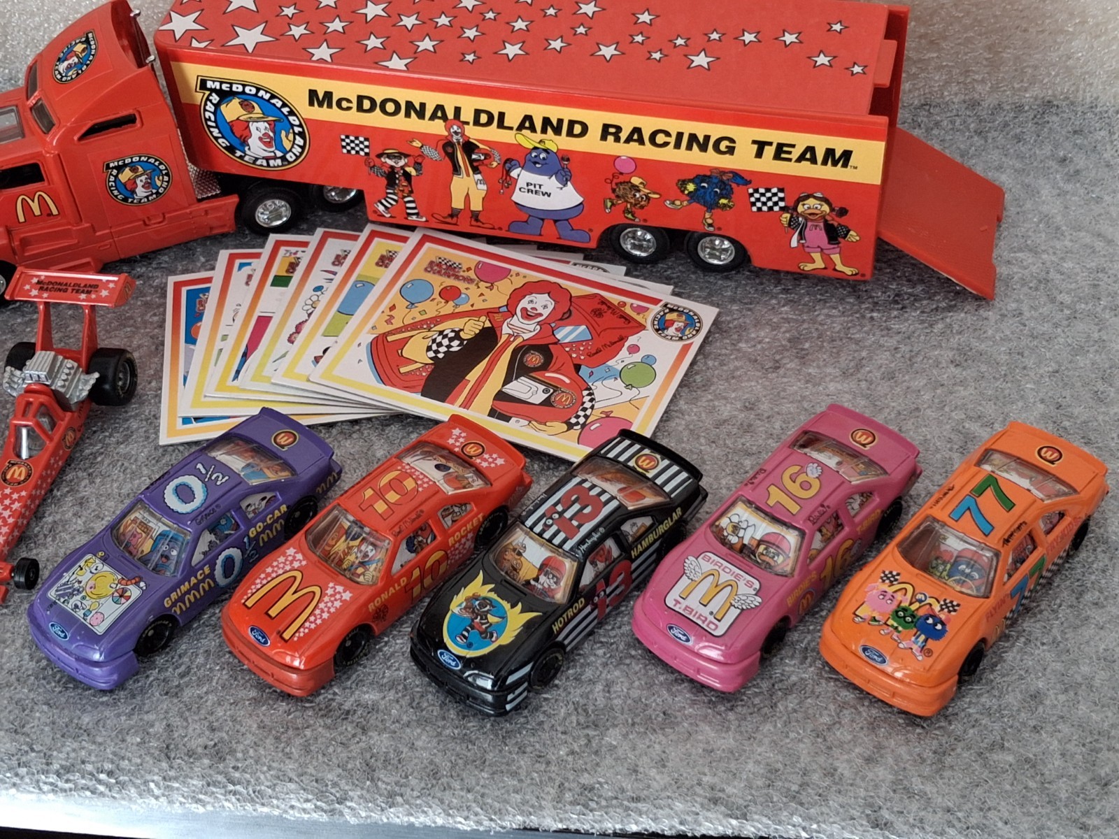 Lot of 1994 McDonaldland Transporter & 7 Car Racing Team set 1-64