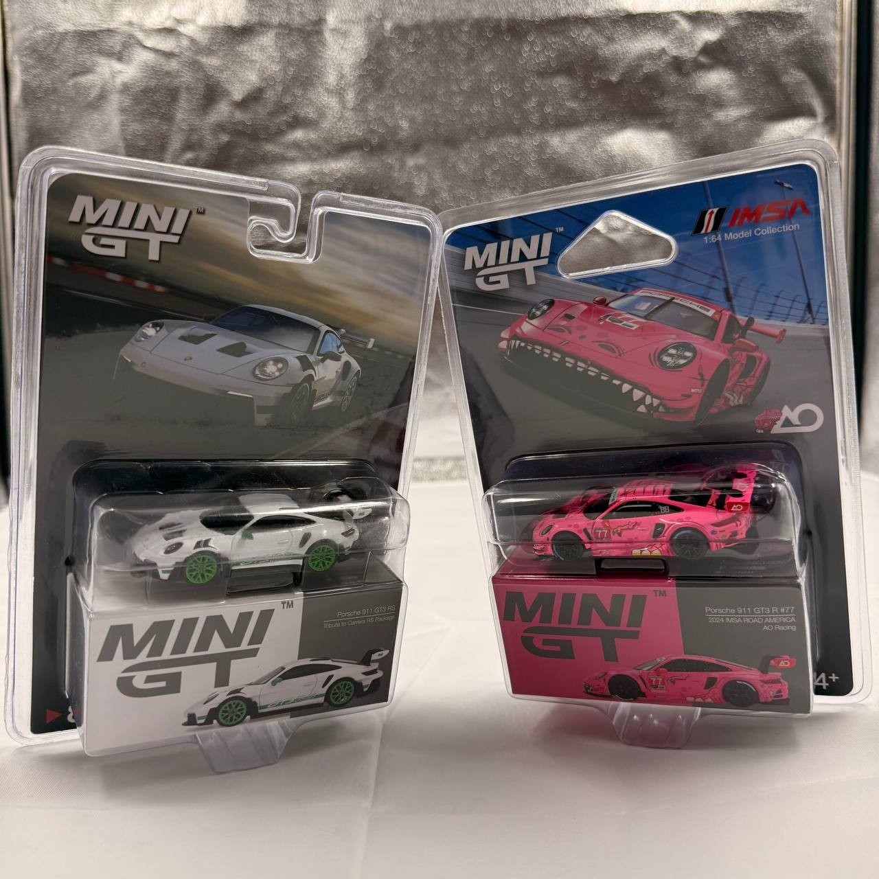Two MINI GT Porsche 911 GT3 R White Carbon Package AO Racing Rexy Pink 1/64
