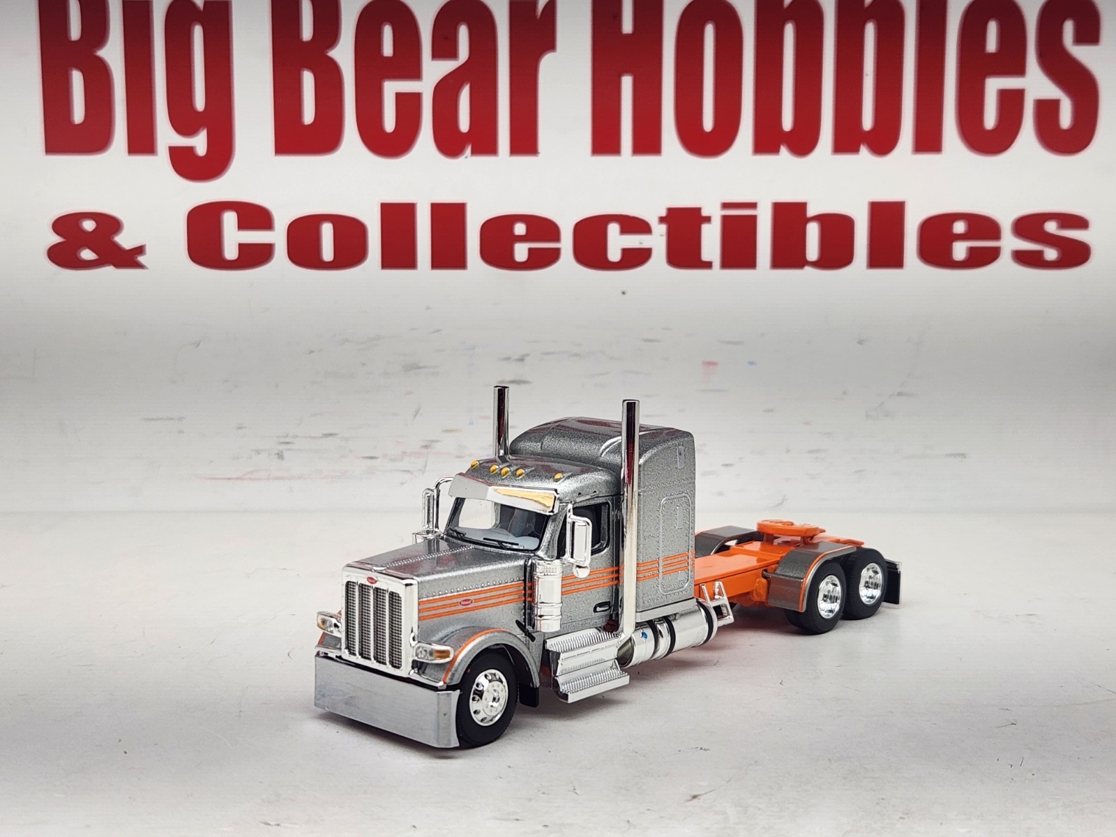 1/64 New DCP Orange & Silver 589 Peterbilt 58″ Mid Roof Sleeper Tractor