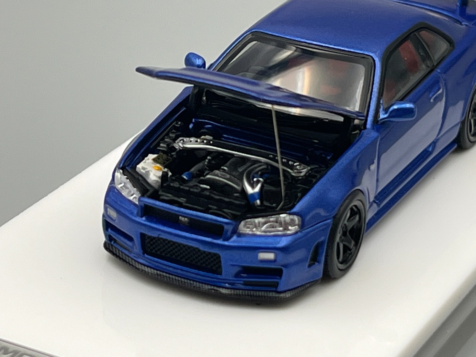 Nissan Skyline NISMO R34 GT-R Z-Tune Bayside Blue MotorHelix 1/64 scale display