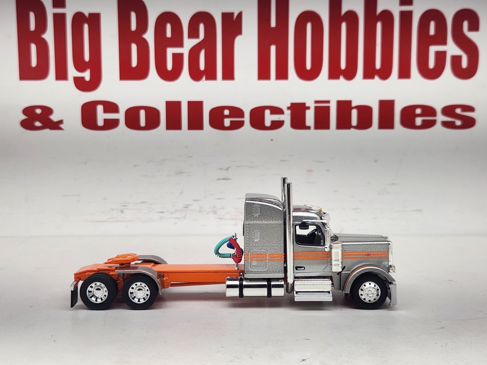 1/64 New DCP Orange & Silver 589 Peterbilt 58″ Mid Roof Sleeper Tractor