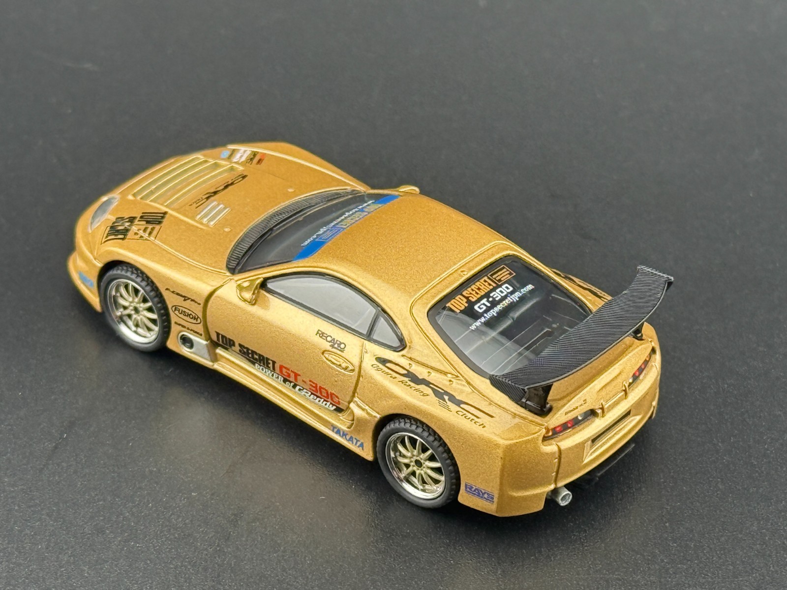 Mini GT Toyota Supra (A80) Top Secret GT-300 – Top Secret Gold #961 1/64