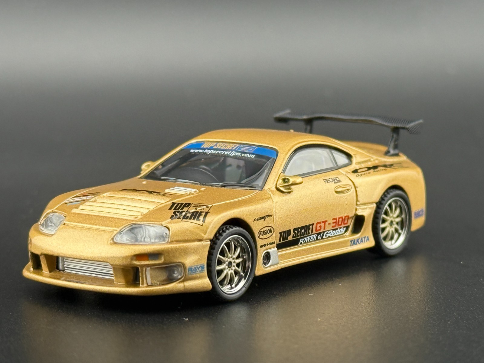 Mini GT Toyota Supra (A80) Top Secret GT-300 – Top Secret Gold #961 1/64