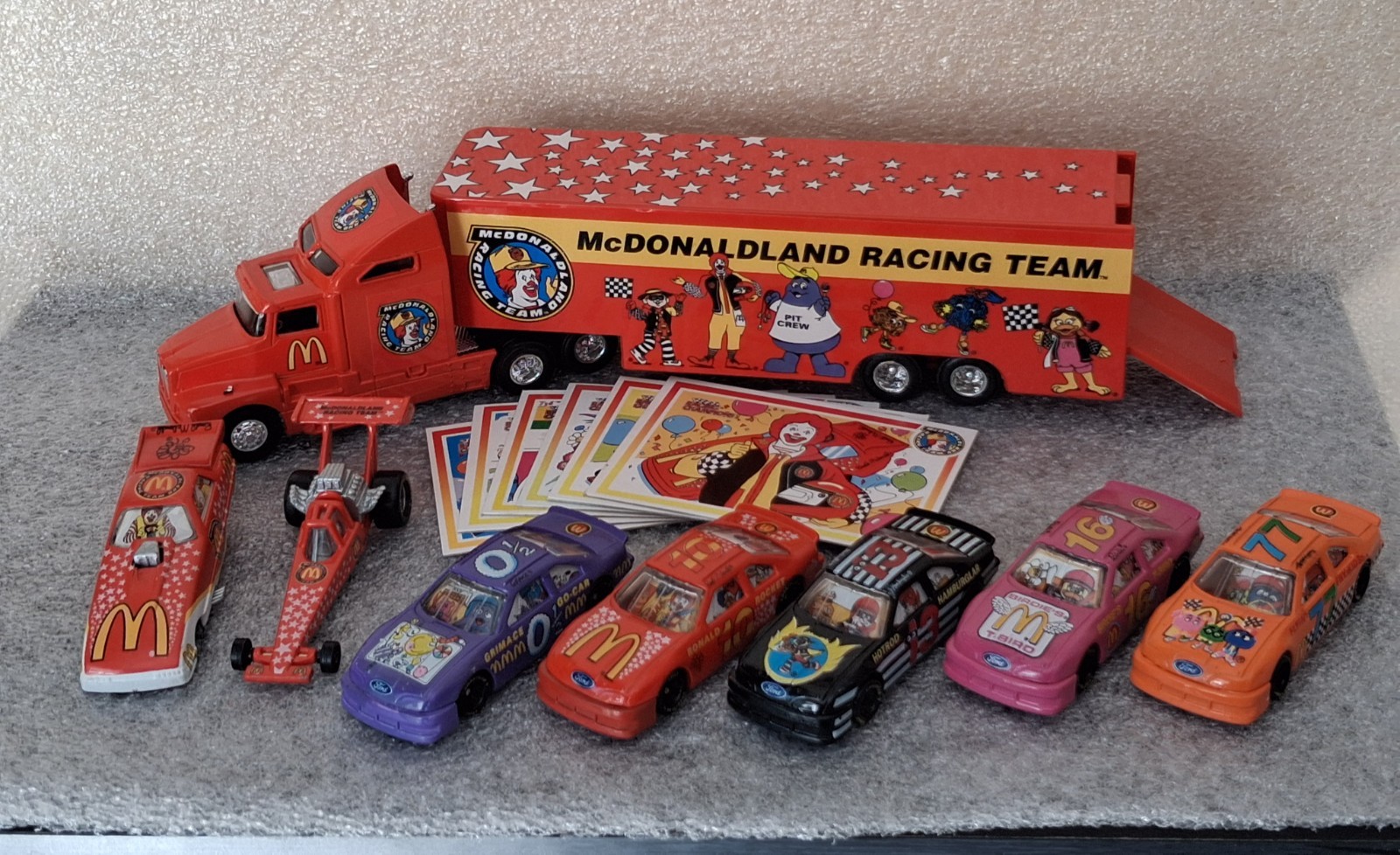 Lot of 1994 McDonaldland Transporter & 7 Car Racing Team set 1-64