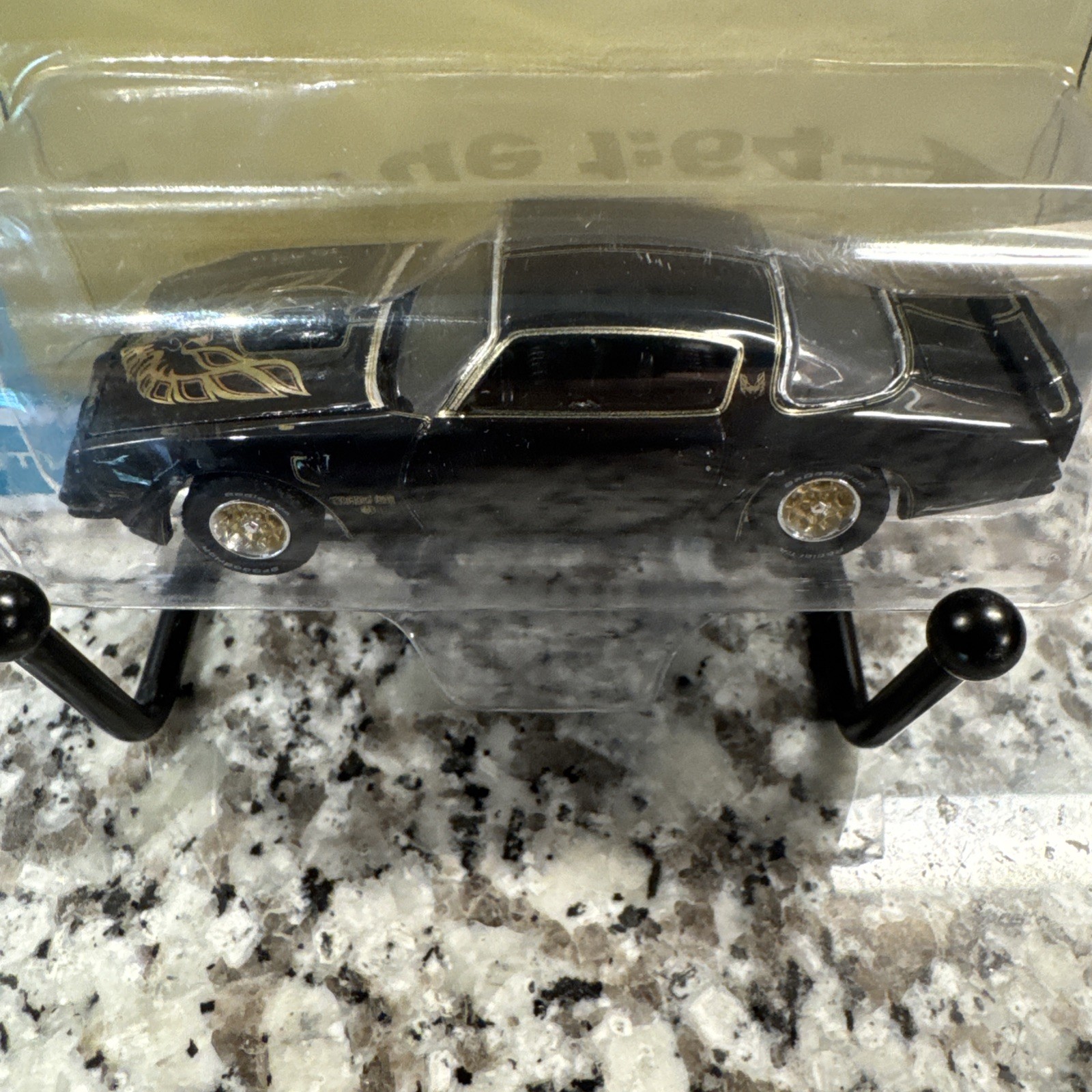 Auto World 1/64 1976 Pontiac Firebird T/A Toy Car – Gloss Black/Gold Bird…