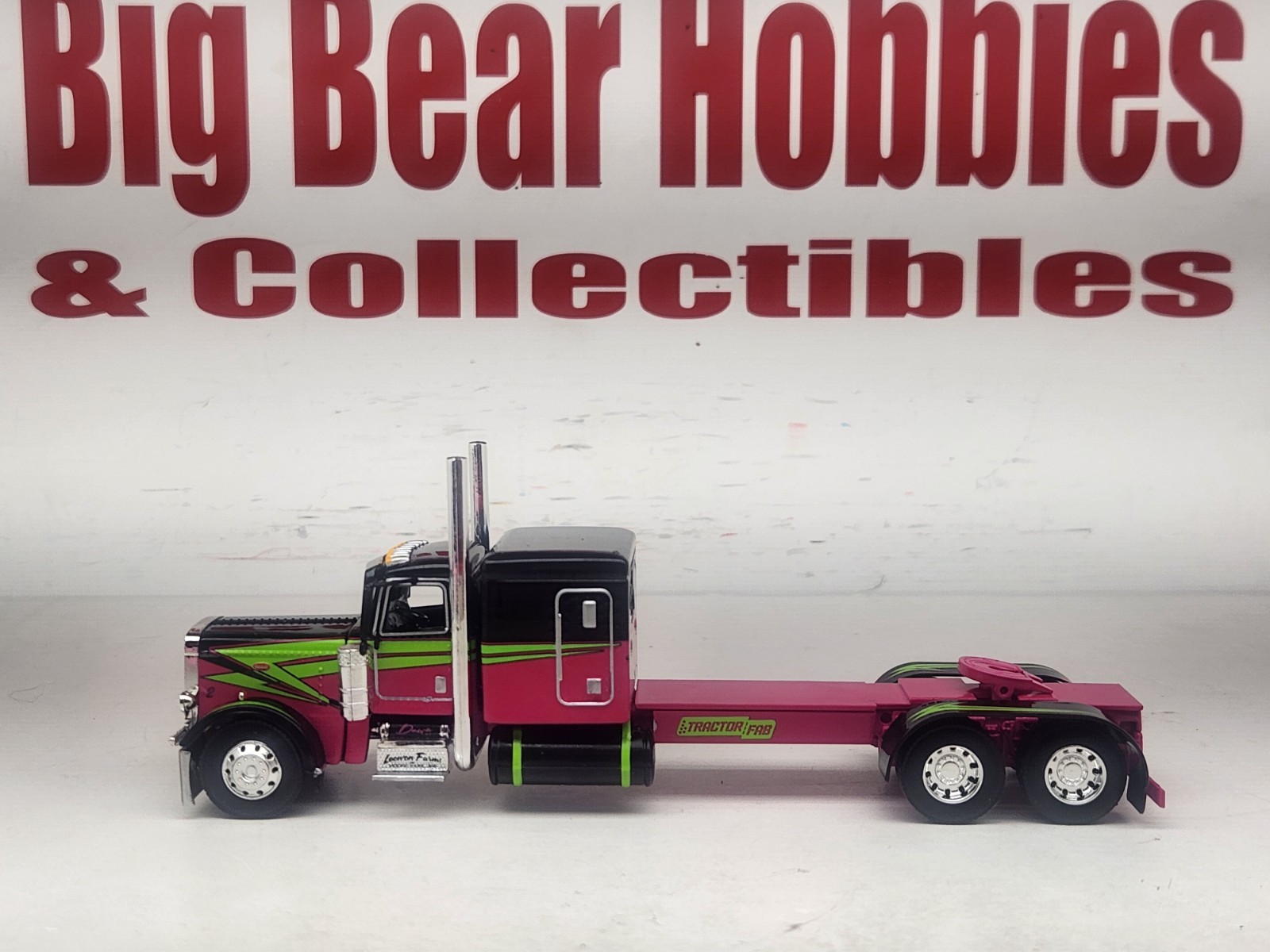 1/64 DCP Loewen Farms Pink, Black 389 Peterbilt With 60″ Flattop Sleeper