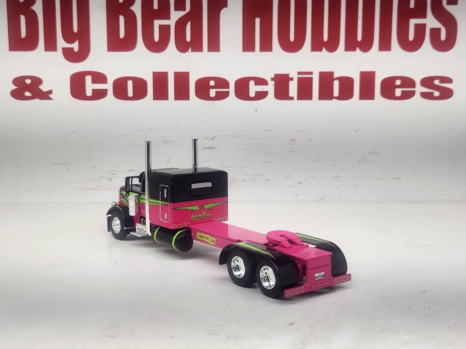 1/64 DCP Loewen Farms Pink, Black 389 Peterbilt With 60″ Flattop Sleeper