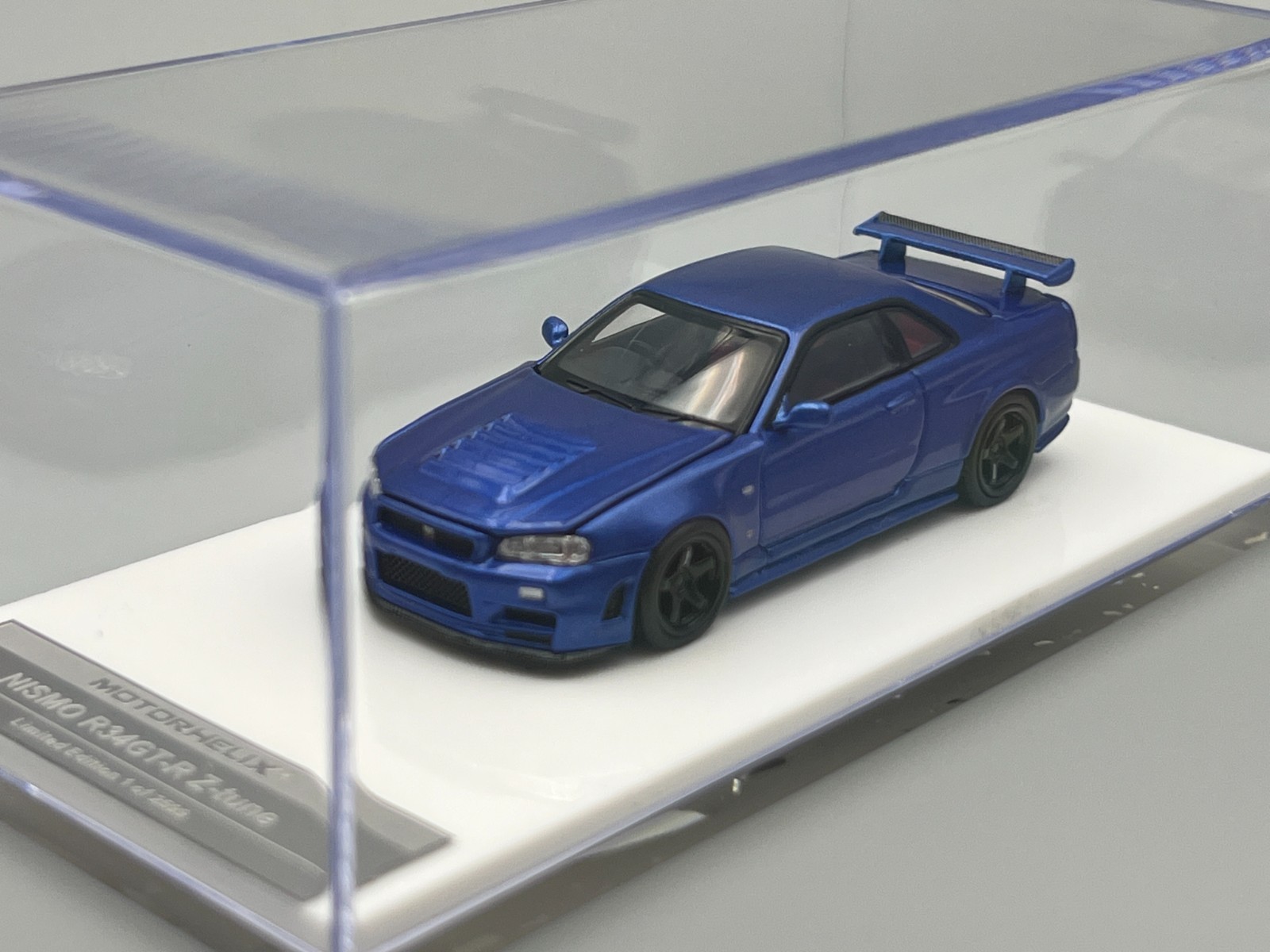 Nissan Skyline NISMO R34 GT-R Z-Tune Bayside Blue MotorHelix 1/64 scale display