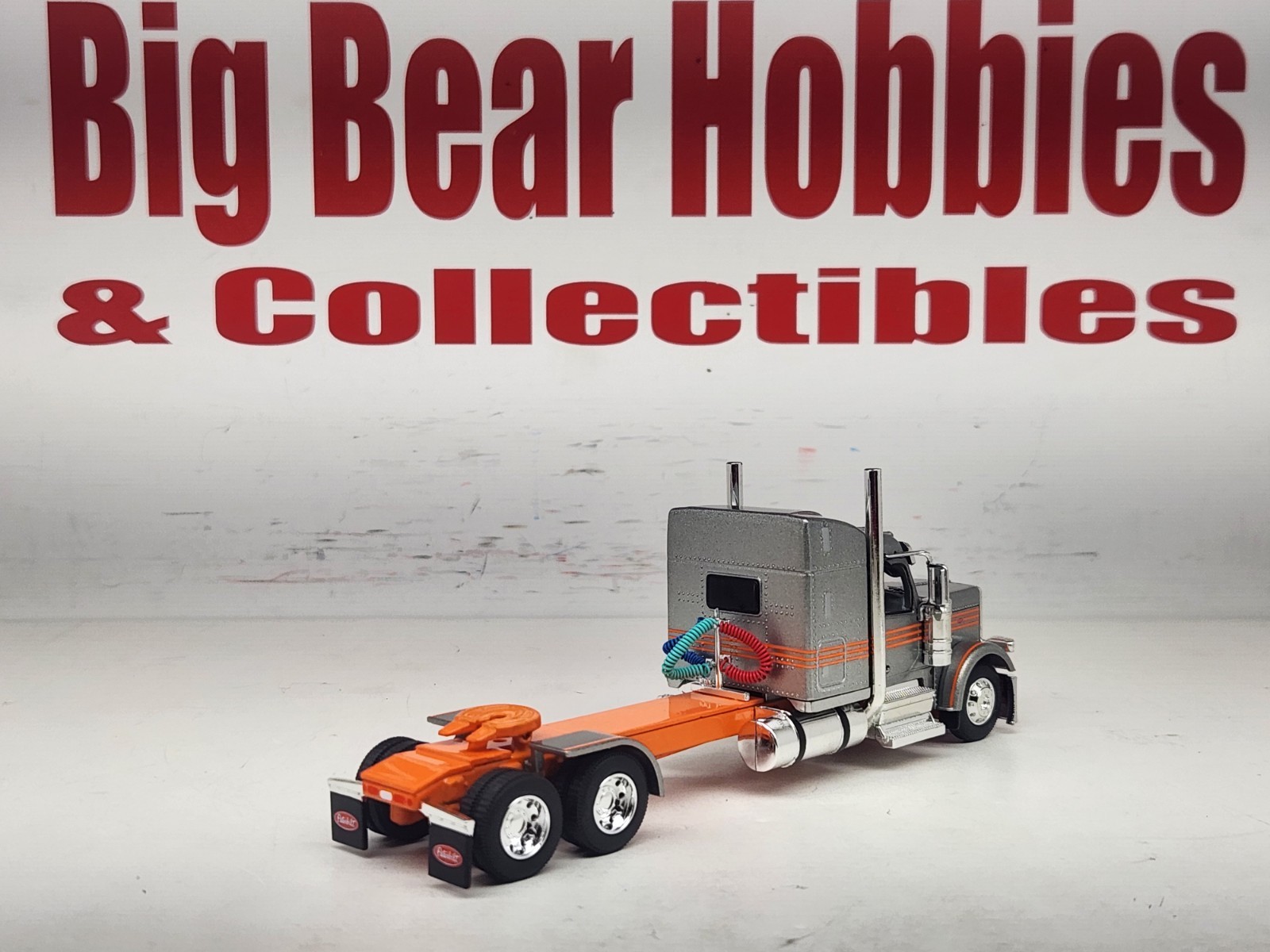 1/64 New DCP Orange & Silver 589 Peterbilt 58″ Mid Roof Sleeper Tractor