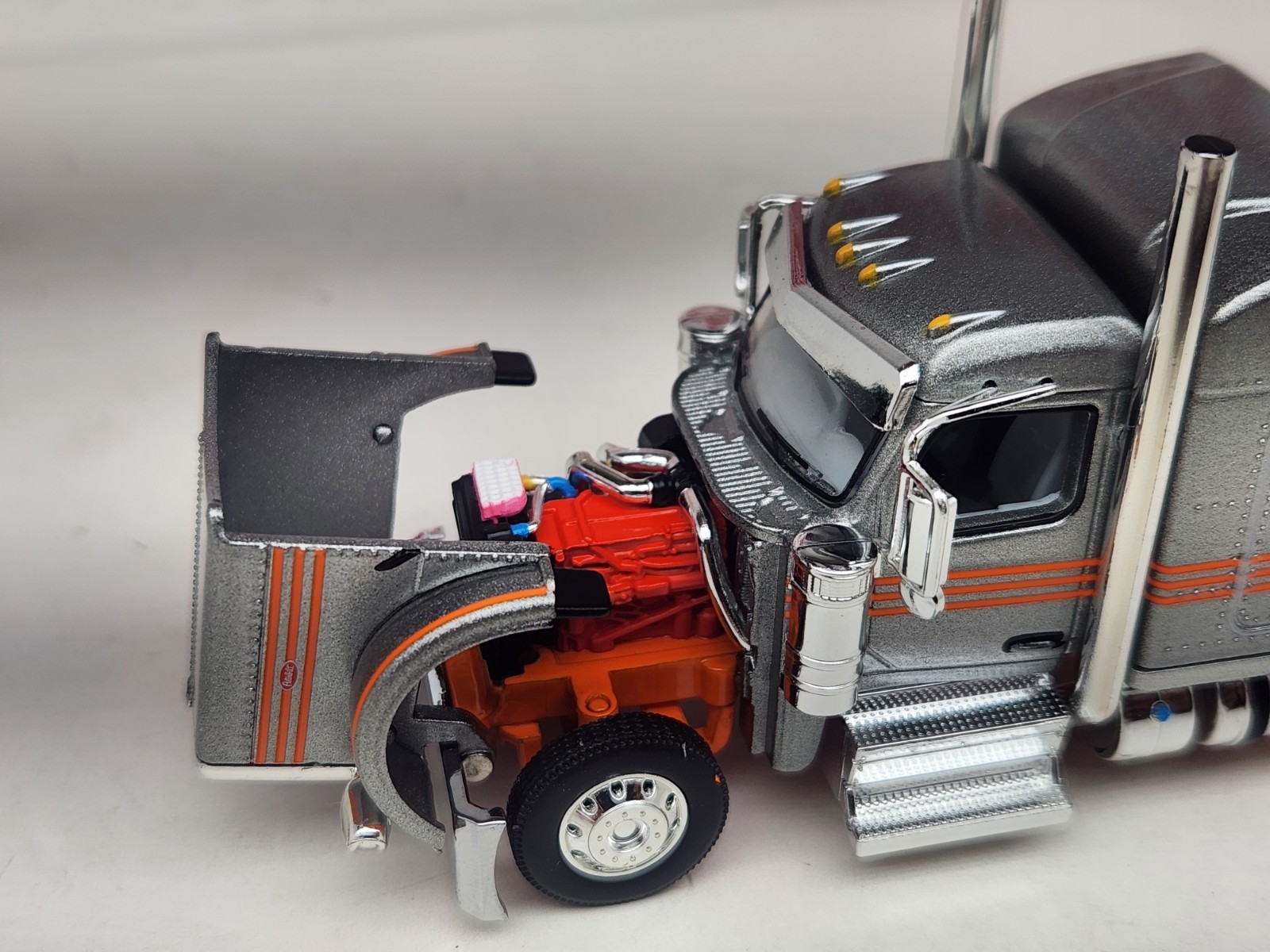 1/64 New DCP Orange & Silver 589 Peterbilt 58″ Mid Roof Sleeper Tractor