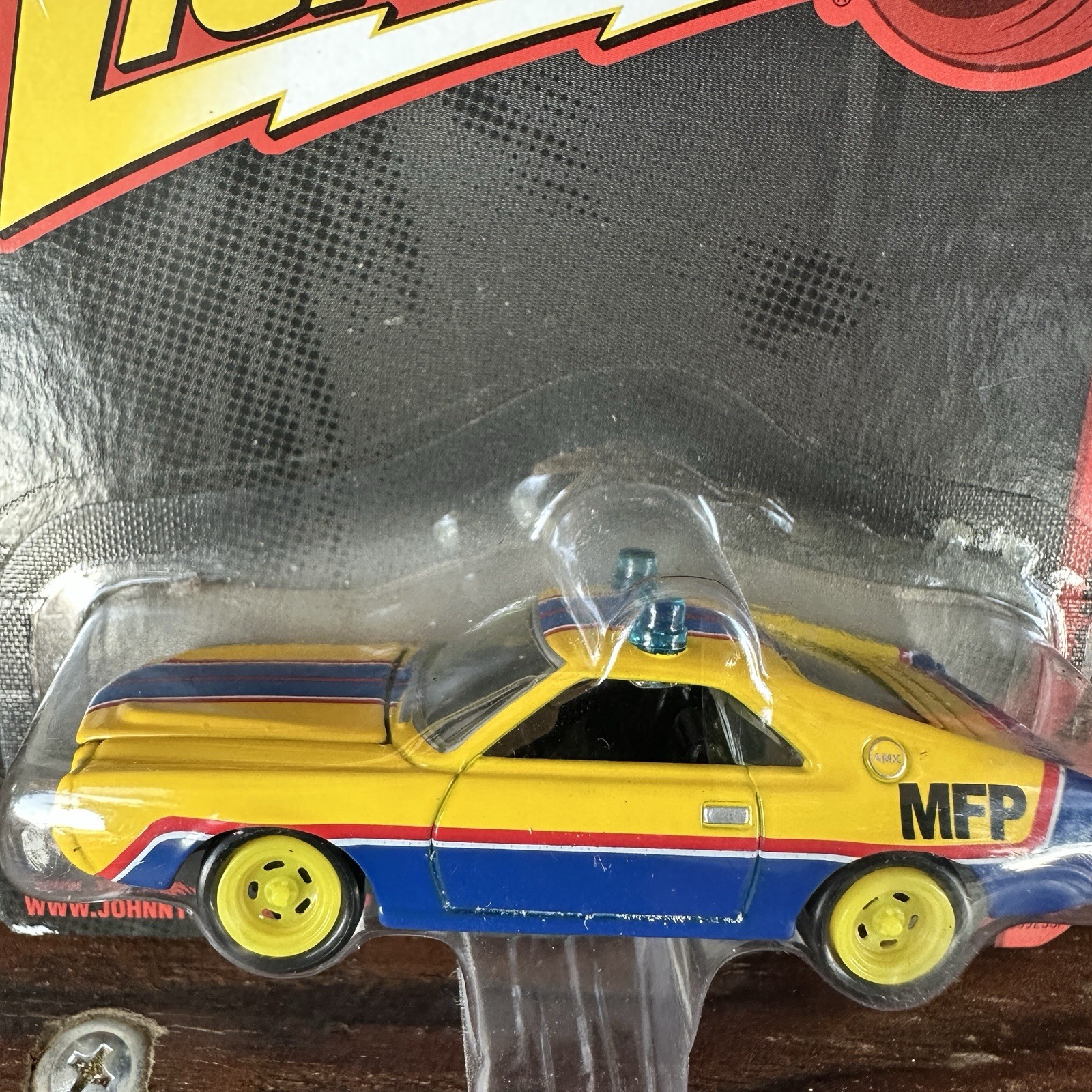 JOHNNY LIGHTNING 1968 AMC AMX IN BLUE AND YELLOW ‘MFP’ FROM MAD MAX