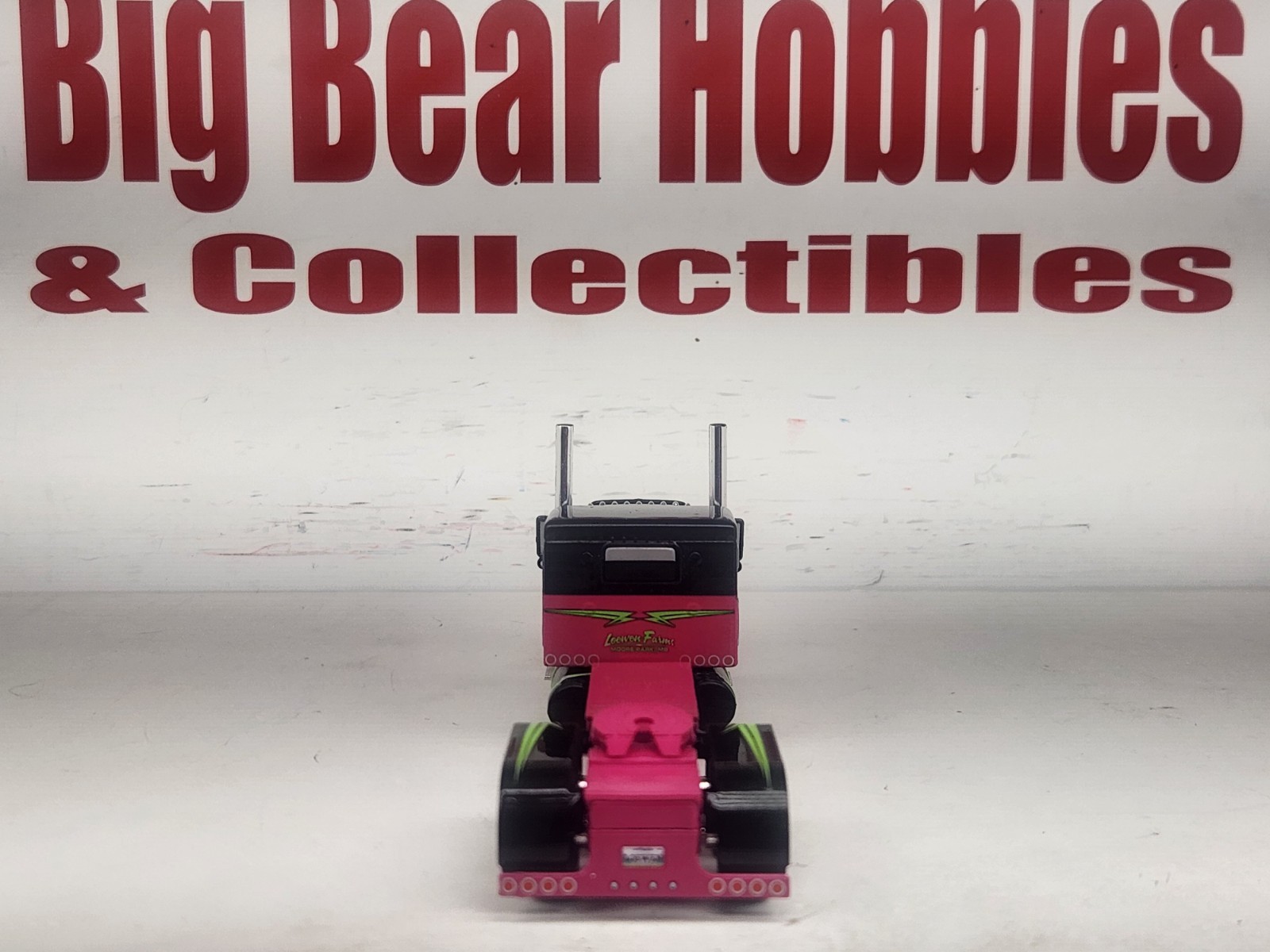 1/64 DCP Loewen Farms Pink, Black 389 Peterbilt With 60″ Flattop Sleeper