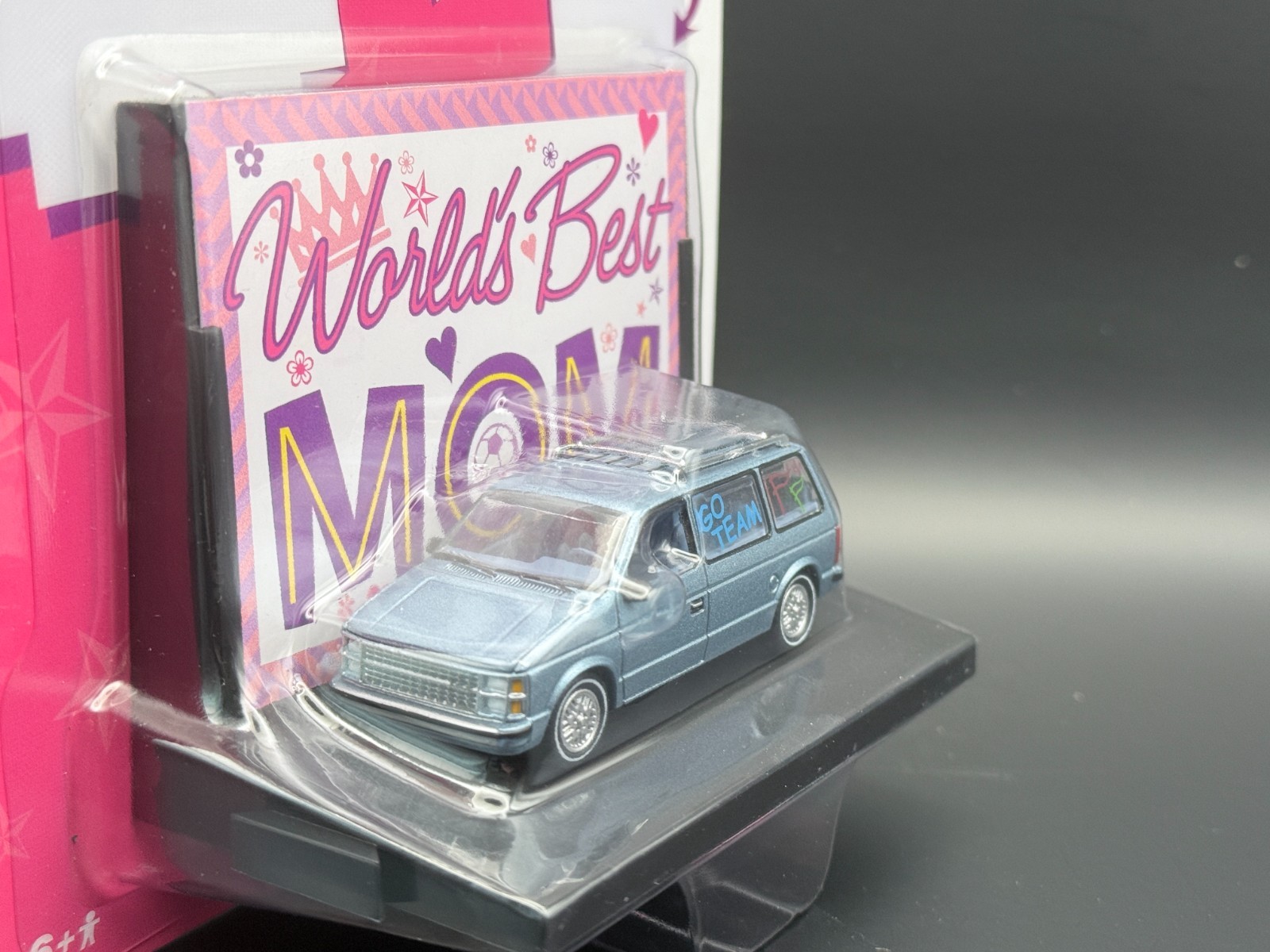 Auto World 1984 Dodge Caravan Blue World’s Best 1/64