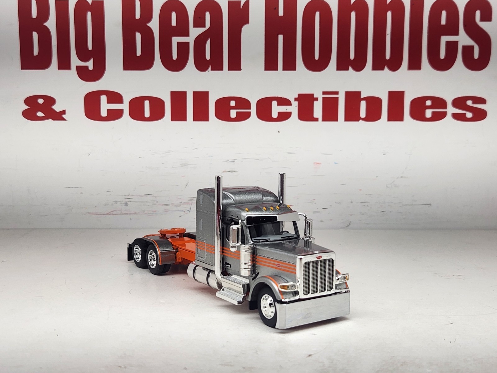 1/64 New DCP Orange & Silver 589 Peterbilt 58″ Mid Roof Sleeper Tractor