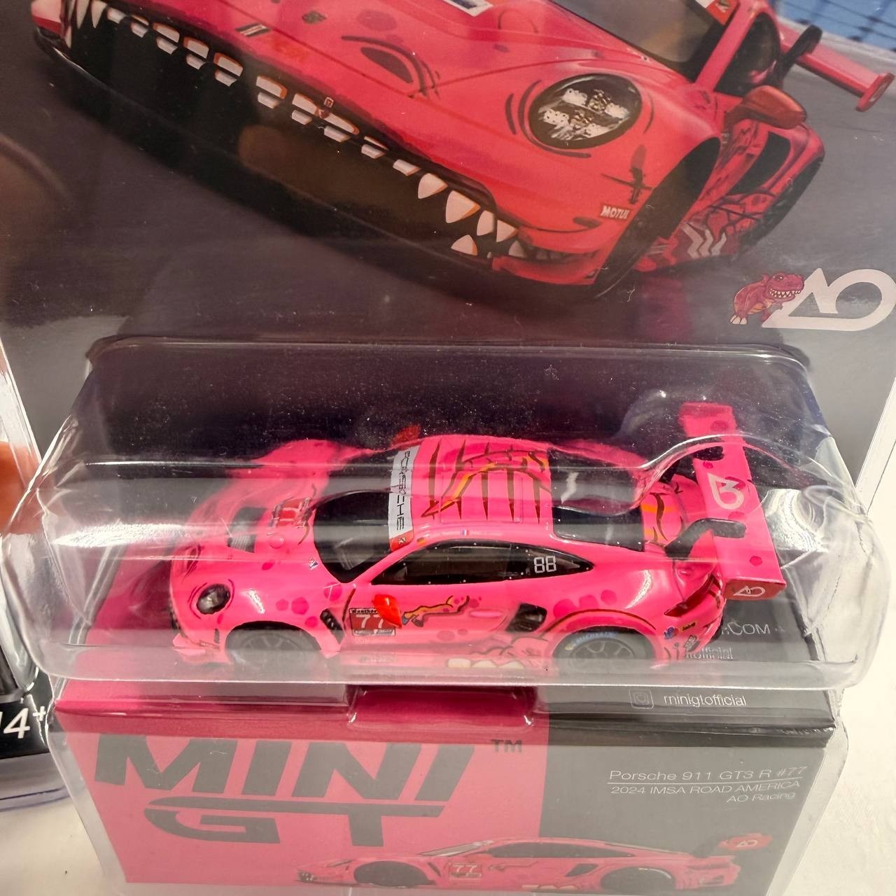 Two MINI GT Porsche 911 GT3 R White Carbon Package AO Racing Rexy Pink 1/64