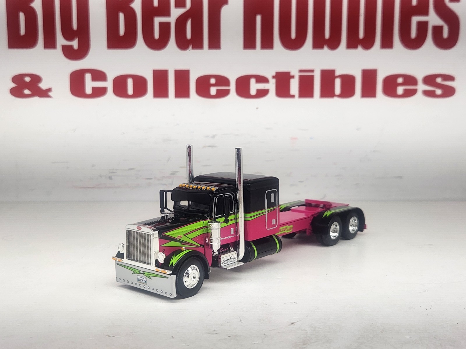 1/64 DCP Loewen Farms Pink, Black 389 Peterbilt With 60″ Flattop Sleeper