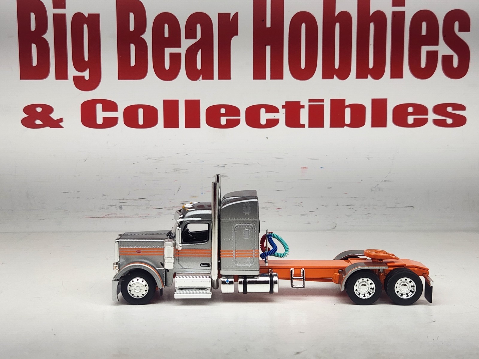 1/64 New DCP Orange & Silver 589 Peterbilt 58″ Mid Roof Sleeper Tractor