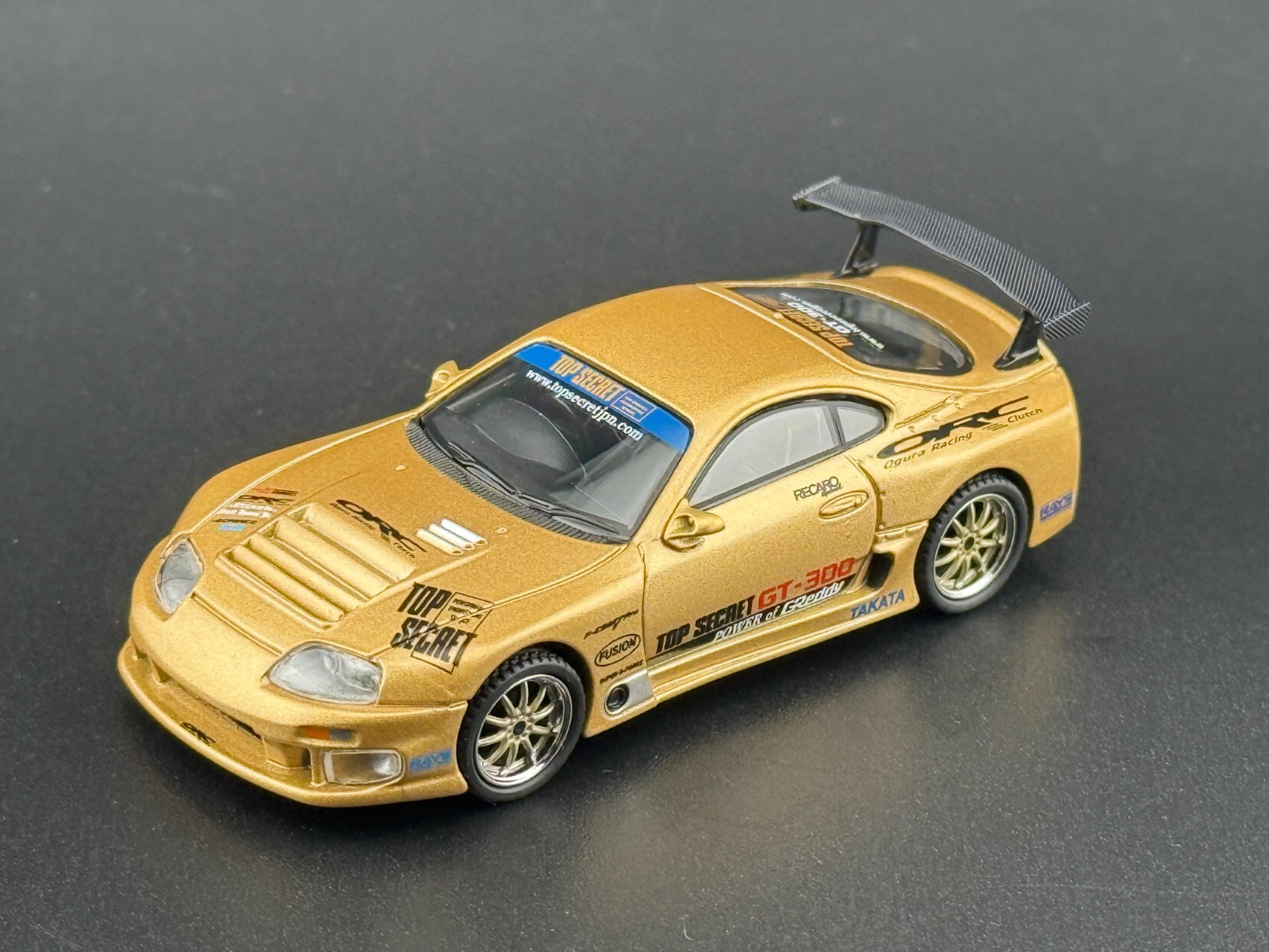Mini GT Toyota Supra (A80) Top Secret GT-300 – Top Secret Gold #961 1/64