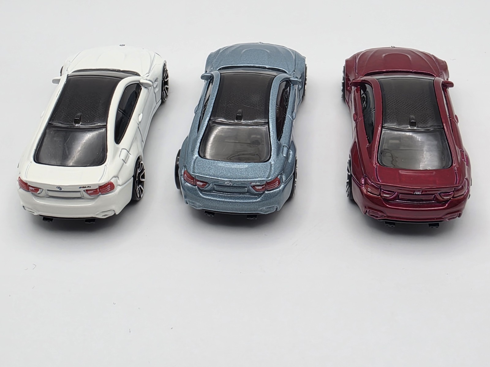LOT OF (3) LOOSE HOT WHEEL BMW M4 IN LIGHT BLUE METALIC, WHITE AND BURGUNDY